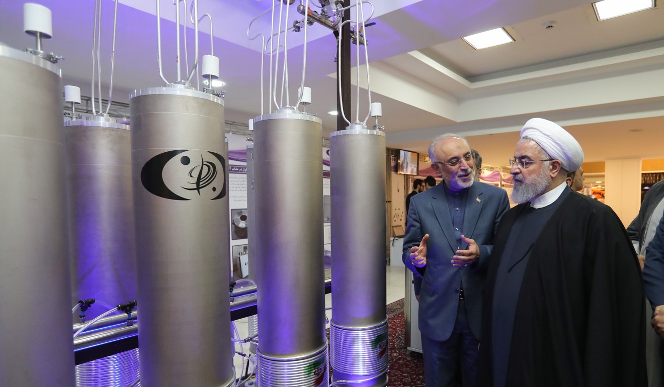 Iranian President Hassan Rowhani (right) and the head of Iran’s nuclear technology organisation Ali Akbar Salehi inspect the country’s nuclear technology on April 9 in Tehran. Photo: EPA-EFE