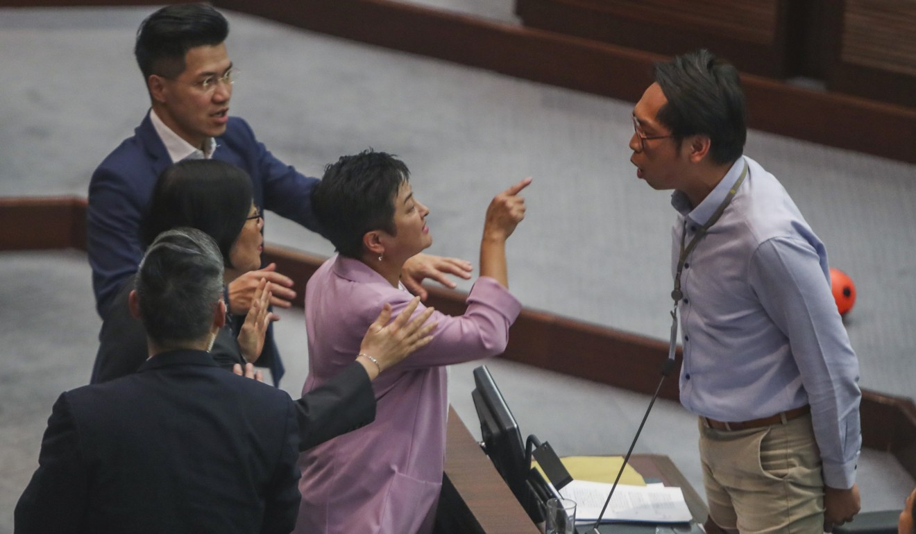 Lawmaker Helena Wong (centre) argues with pro-establishment lawmaker Michael Luk. Photo: Winson Wong