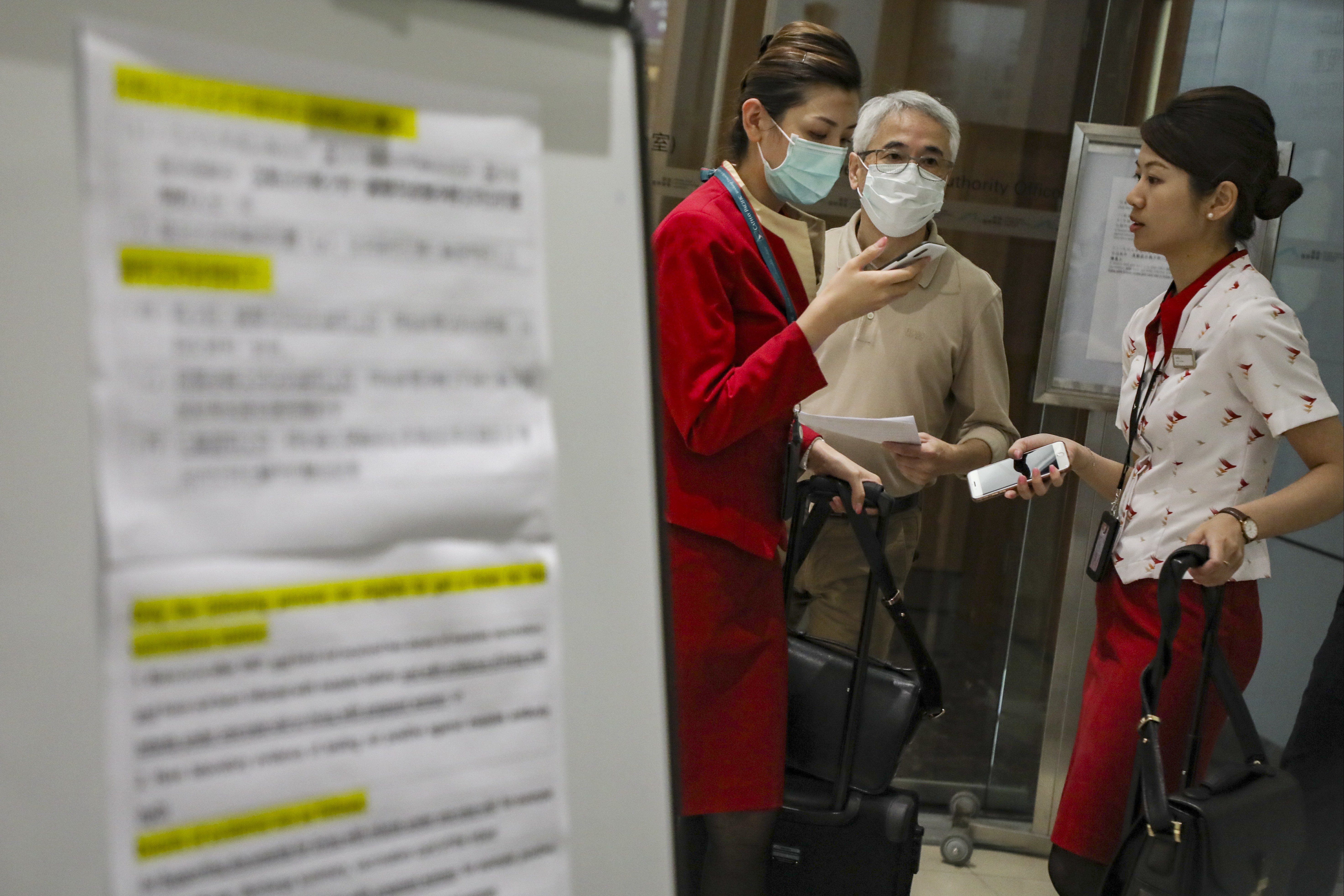 Airline staff queue up for the measles vaccination at Hong Kong’s airport. Photo: Felix Wong