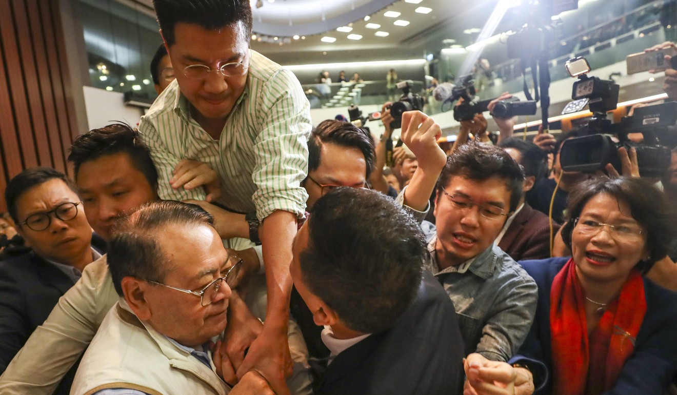 NeoDemocrat Gary Fan (top) grapples with Abraham Razack amid the mess. Photo: Winson Wong
