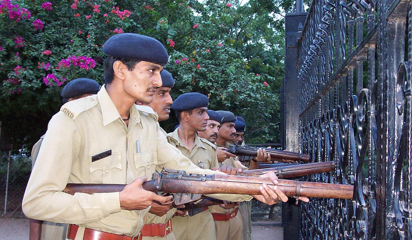 Gujarat police take up a position outside a Hindu temple stormed by gunmen during the 2002 Gujarat communal riots. Photo: AFP