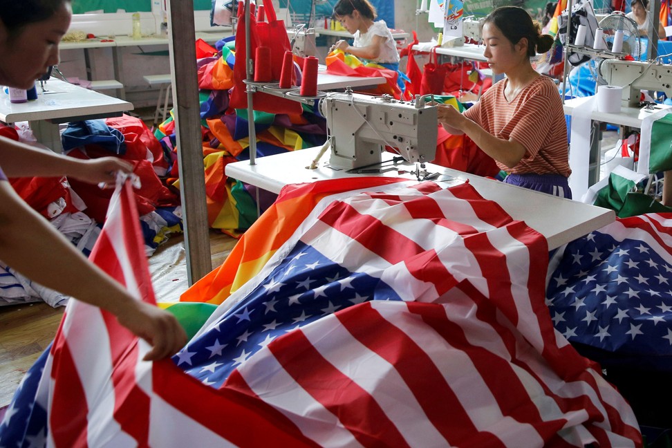 A worker makes US national flags at Jiahao flag factory in Fuyang, Anhui province, China. Photo: Reuters