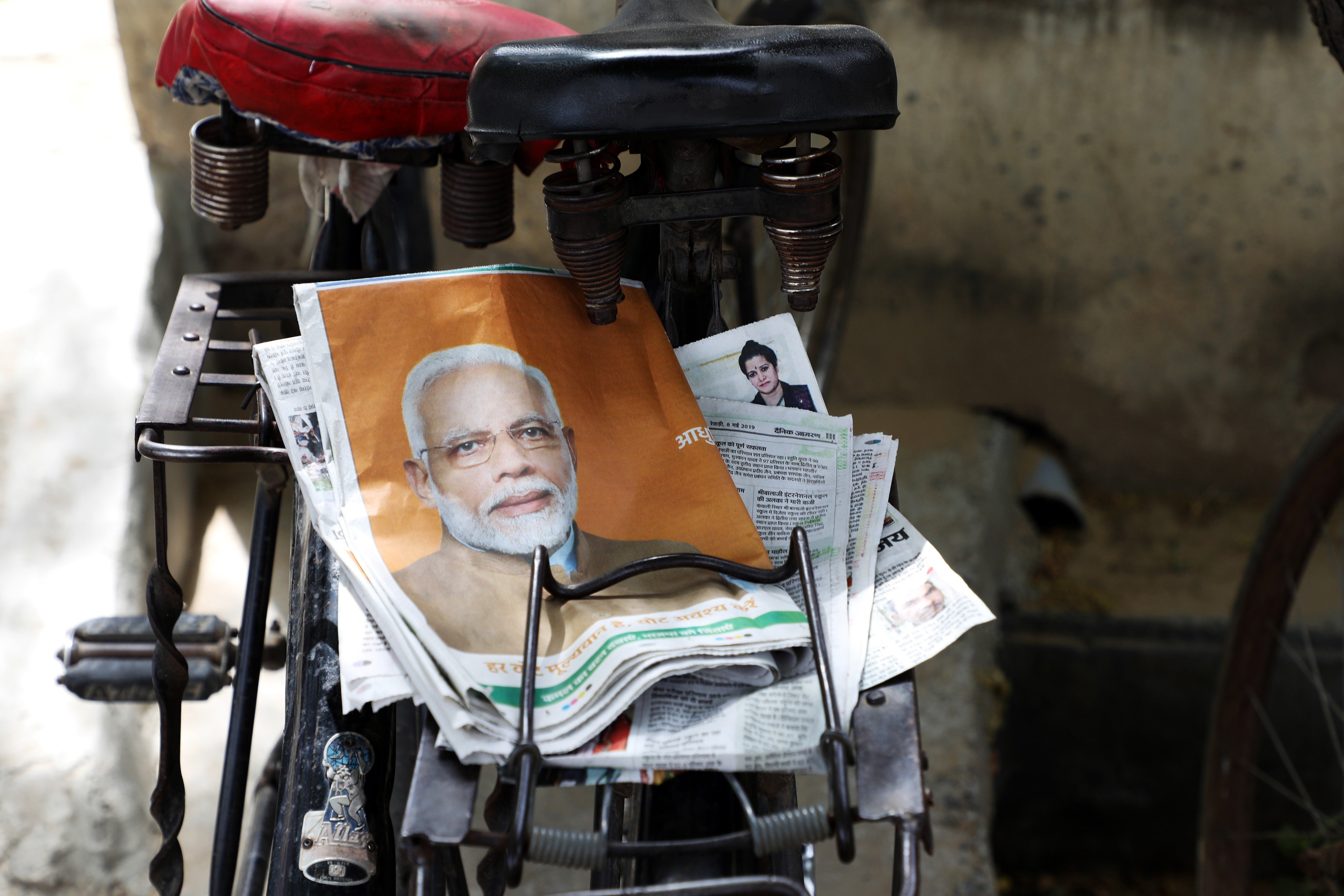 A newspaper with a wraparound cover featuring an image of Indian Prime Minister Narendra Modi sits on a bicycle rack in rural Haryana, India, on May 8. Investment in a strong state unlocks many possible options for tackling India’s housing crisis. Photo: Bloomberg