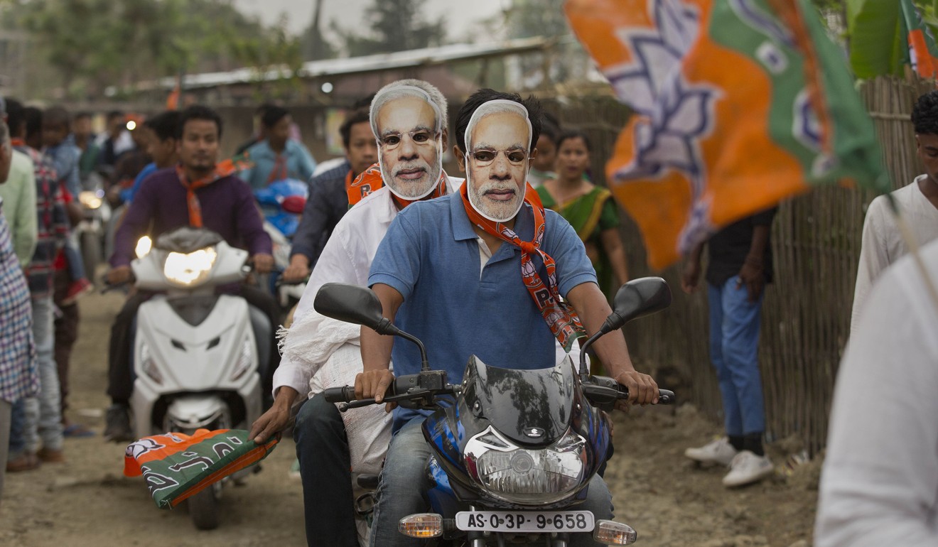Bharatiya Janata Party supporters wear masks of Indian Prime Minister Narendra Modi during an election campaign rally. Photo: AP
