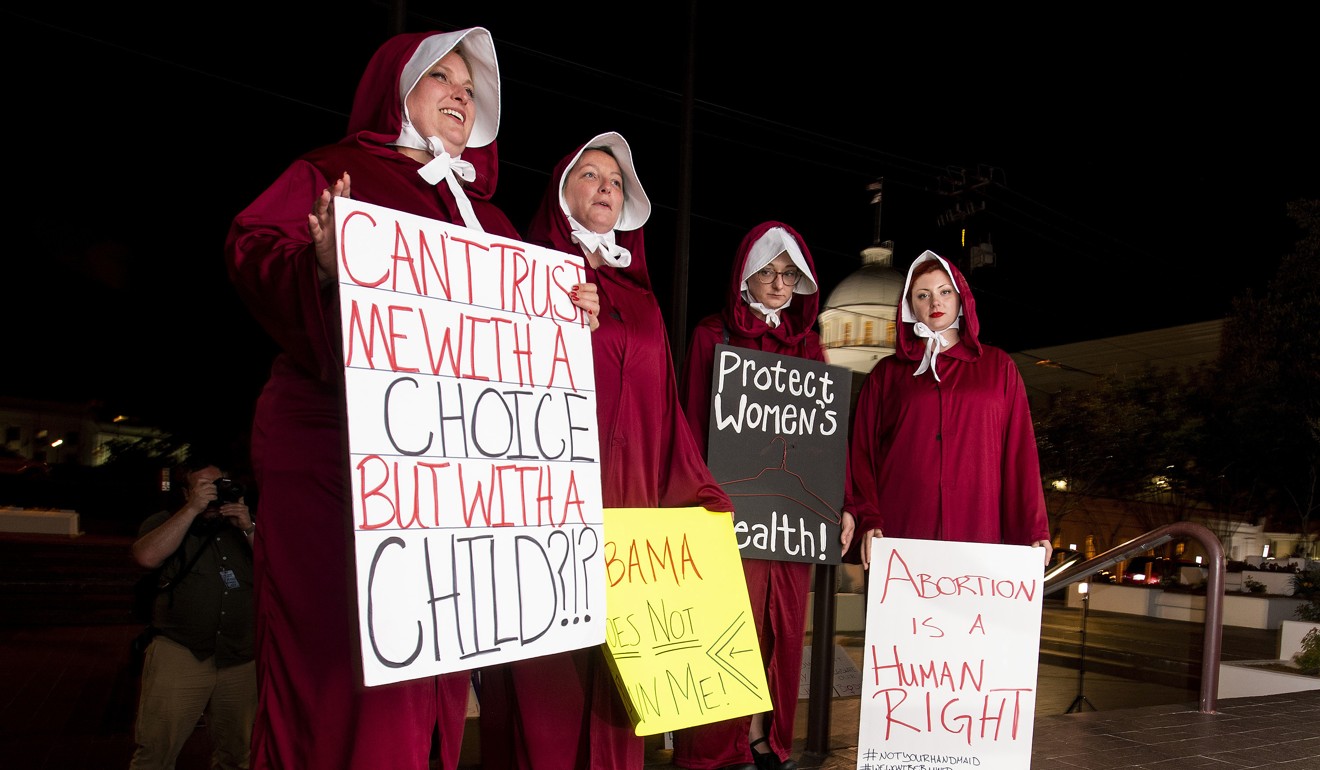 Protesters, dressed as handmaids, wait outside the Alabama statehouse after a ban on nearly all abortions passed the senate in Montgomery. Photo: AP
