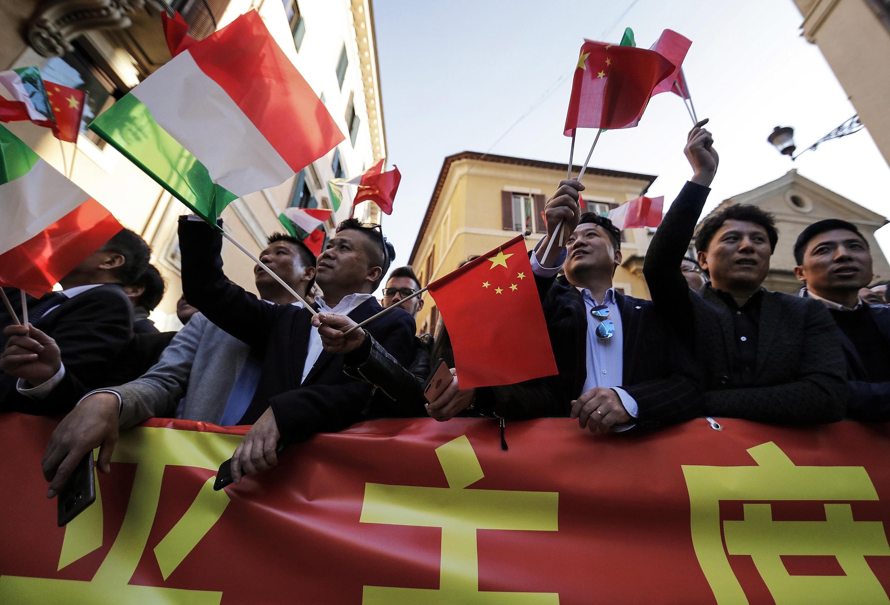 Chinese residents of Italy wave Chinese and Italian flags as they wait for the arrival of Xi Jinping in Rome on March 22. China has long viewed language instruction as a necessary component for achieving diplomacy and trade goals, and the Belt and Road Initiative has resulted in a wave of new languages as majors. Photo: EPA-EFE