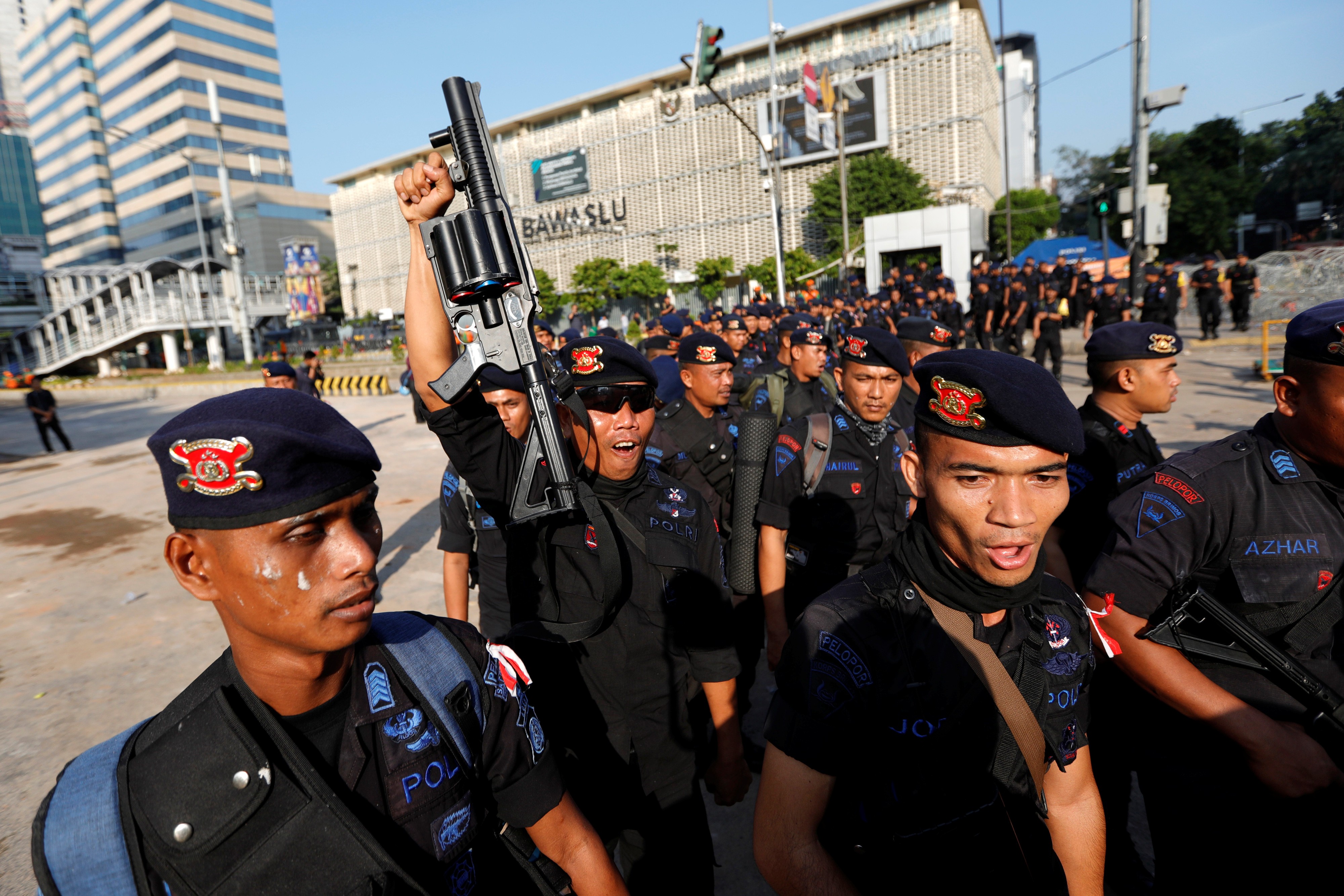 Police officers leave a protest area outside the Election Supervisory Agency (Bawaslu) headquarters in Jakarta. Photo: Reuters