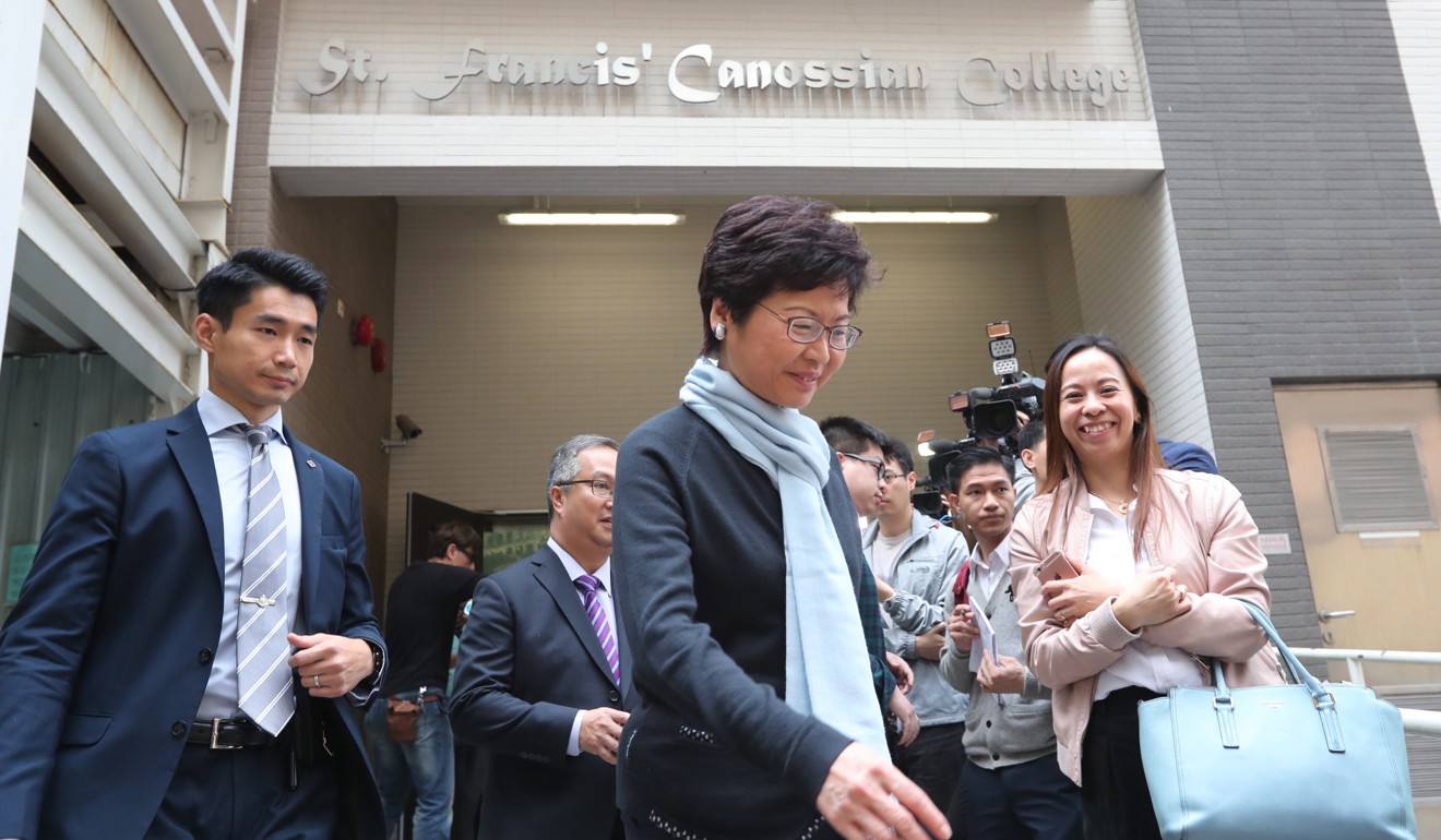 Carrie Lam on a visit to her old school, where not everyone agrees with her extradition policy. Photo: Edward Wong
