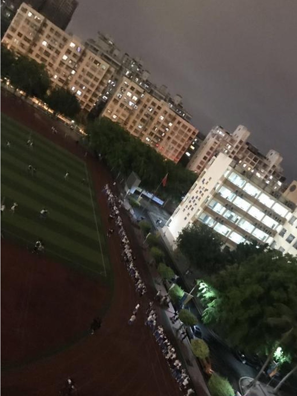Students are seen in a long queue to enter their dormitories at the middle school in Haikou. Photo: Weibo