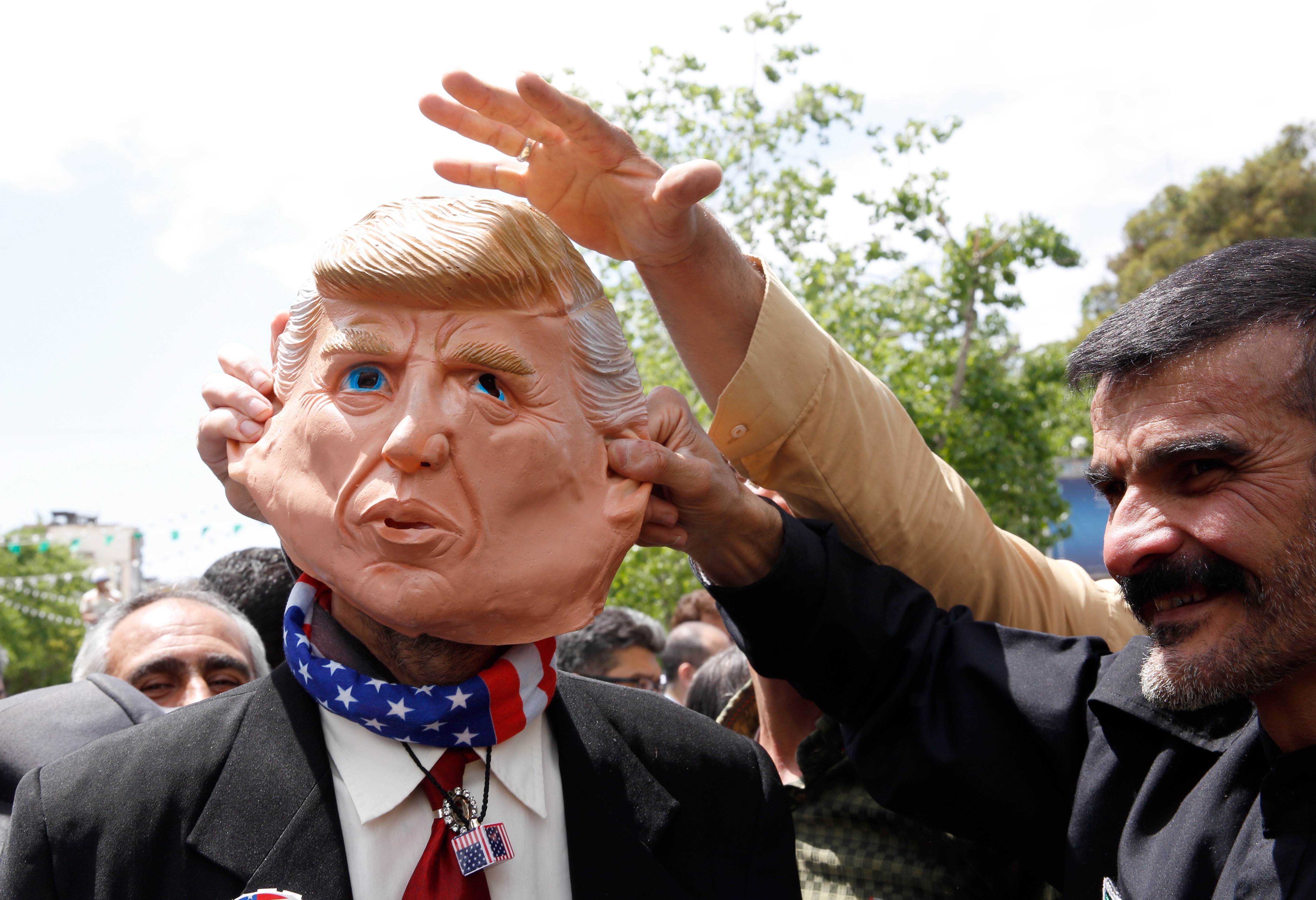 Demonstrators tug at a mask of President Donald Trump at an anti-US rally in Iran on May 10. Whether it is Iran, North Korea, Venezuela or China, Trump has failed to solve the knottiest US foreign policy dilemmas with the sheer force of his deal-making savvy or charisma. Photo: EPA-EFE