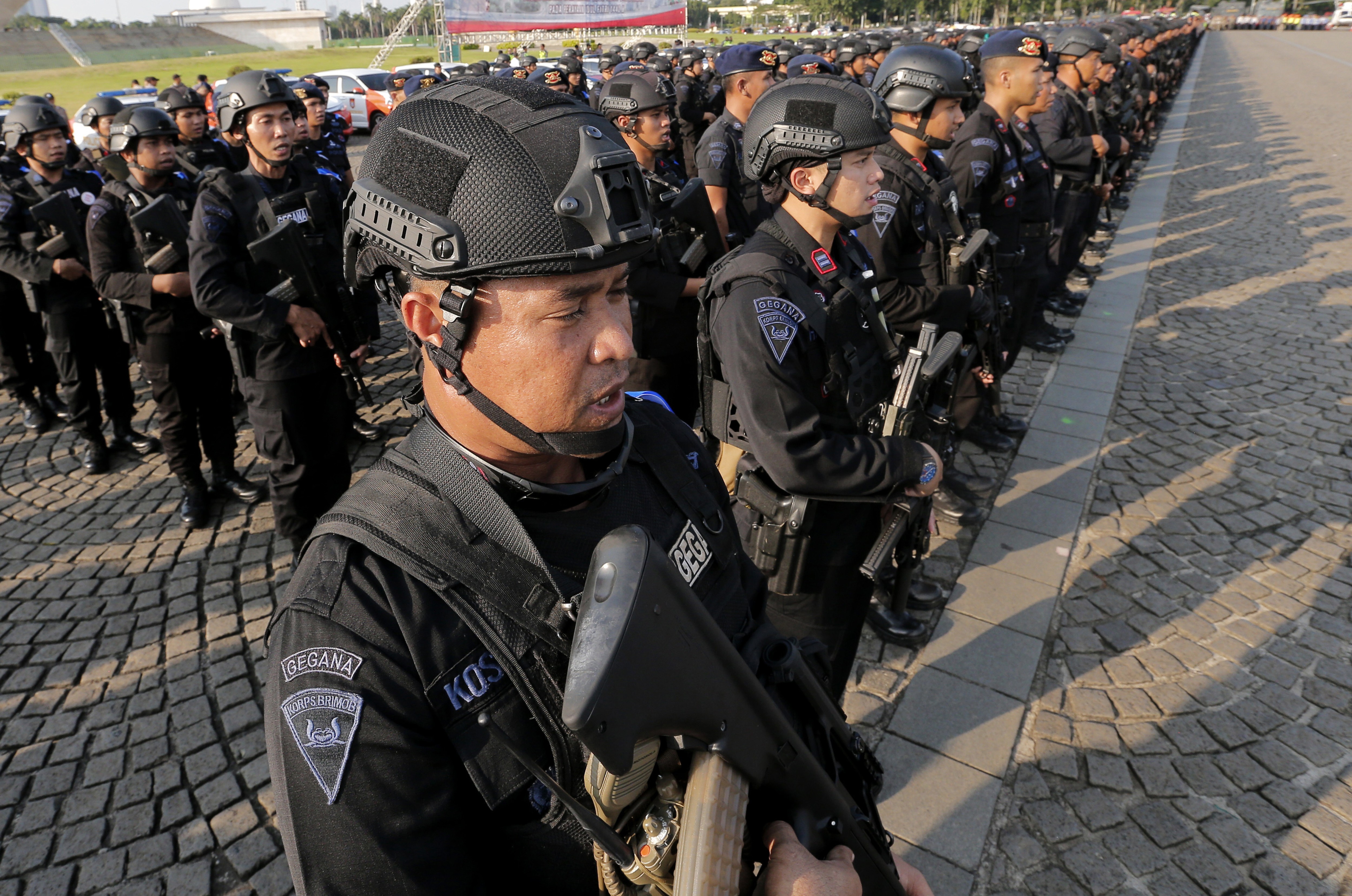 Police officers stand in attention during a show of force on Tuesday in Jakarta. Photo: AP