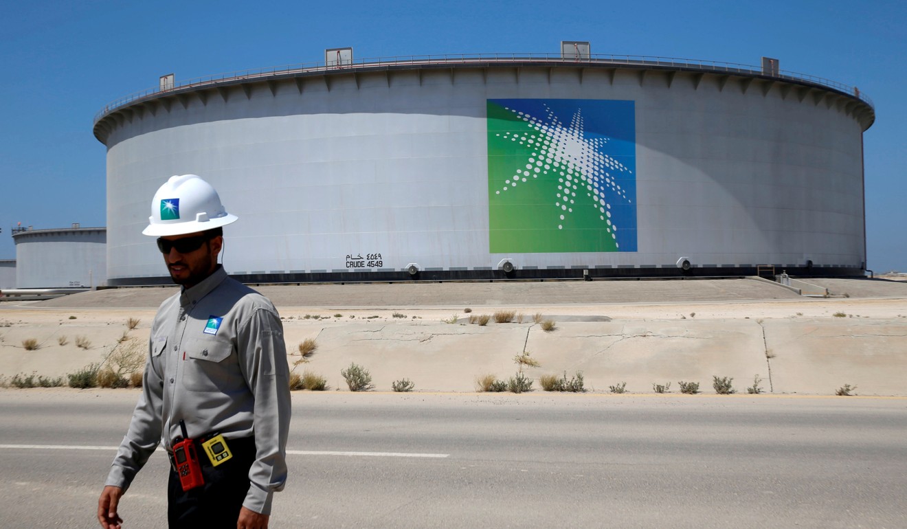 An Aramco employee near an oil tank in Saudi Arabia. Aramco has grand ambitions to become a major producer of natural gas. Photo: Reuters