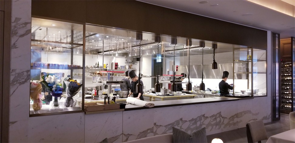 The large open kitchen, which stretches the length of L’Envol restaurant.