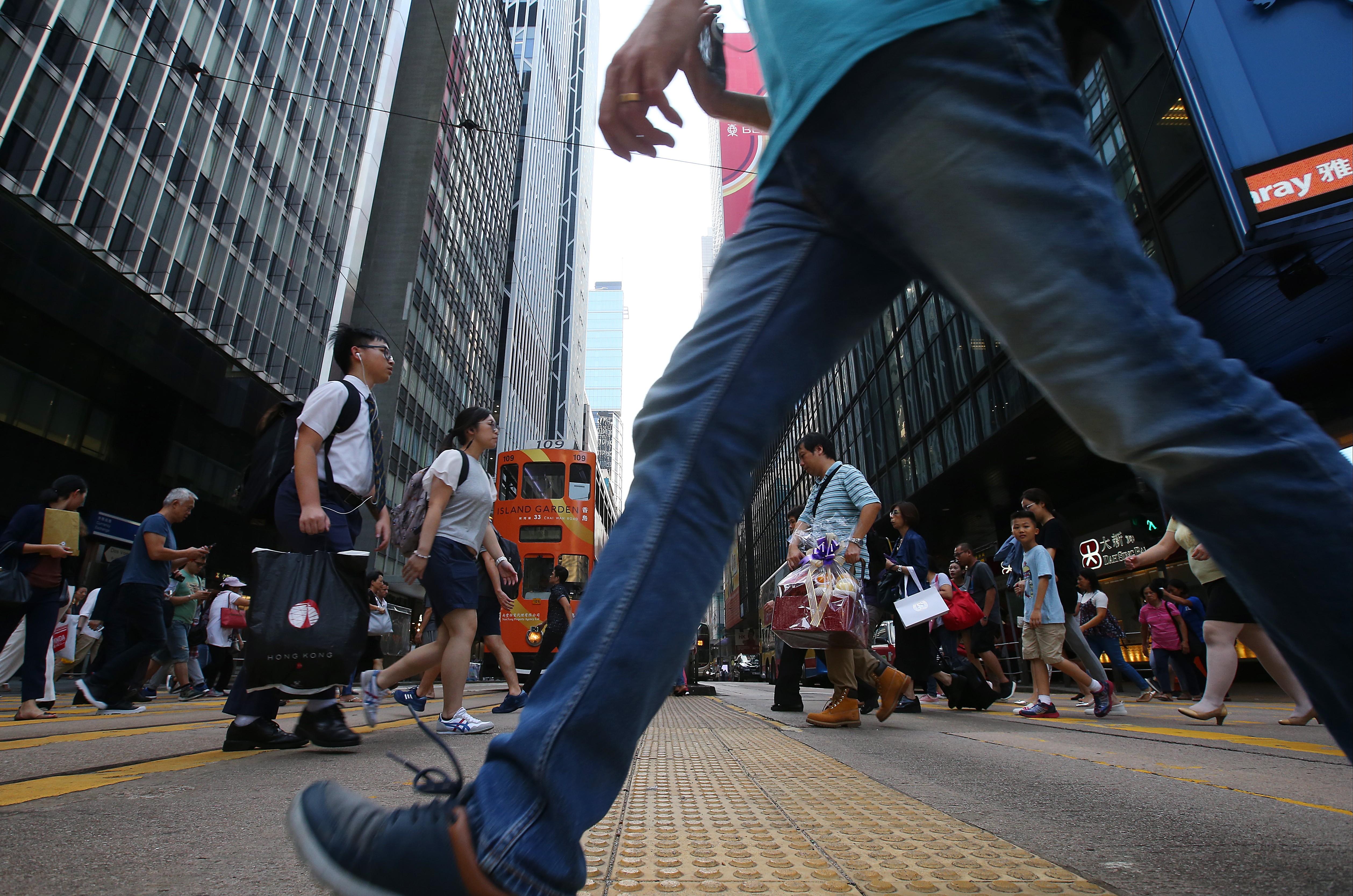 A pedestrian crosses the street in Central, one of the districts targeted for walkability trials. Photo: K. Y. Cheng