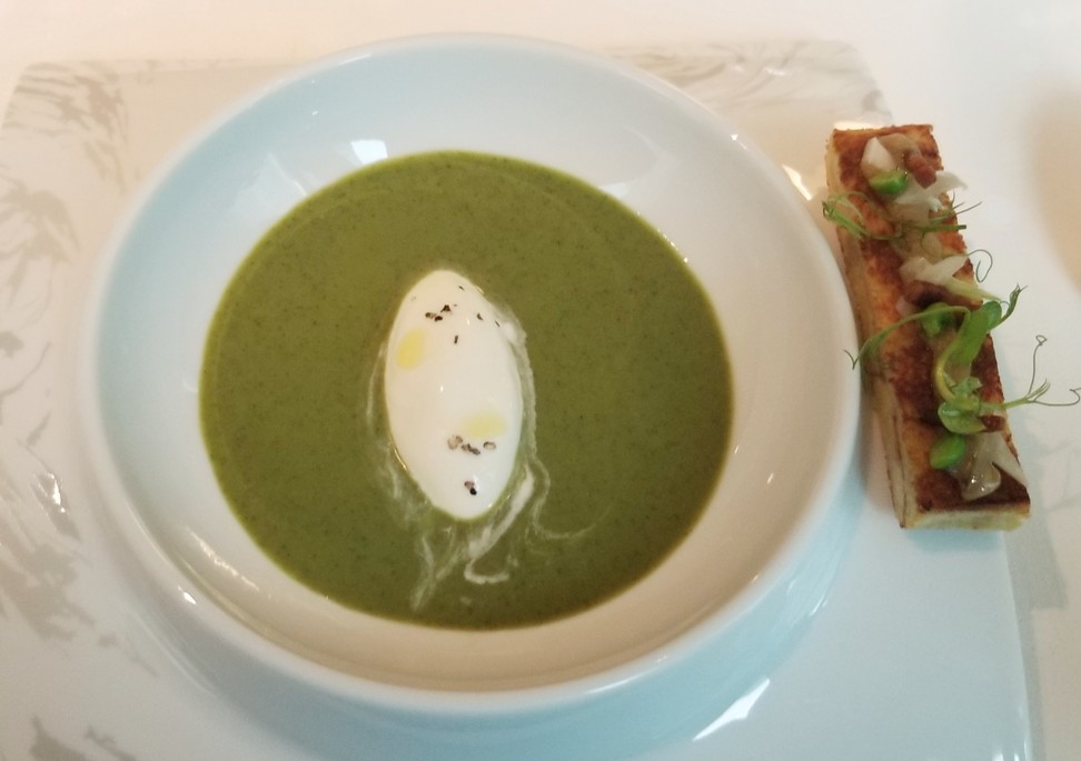 Chilled French green pea cream and mint soup, with smoked burrata ice cream, served as part of L’Envol’s tasting menu.