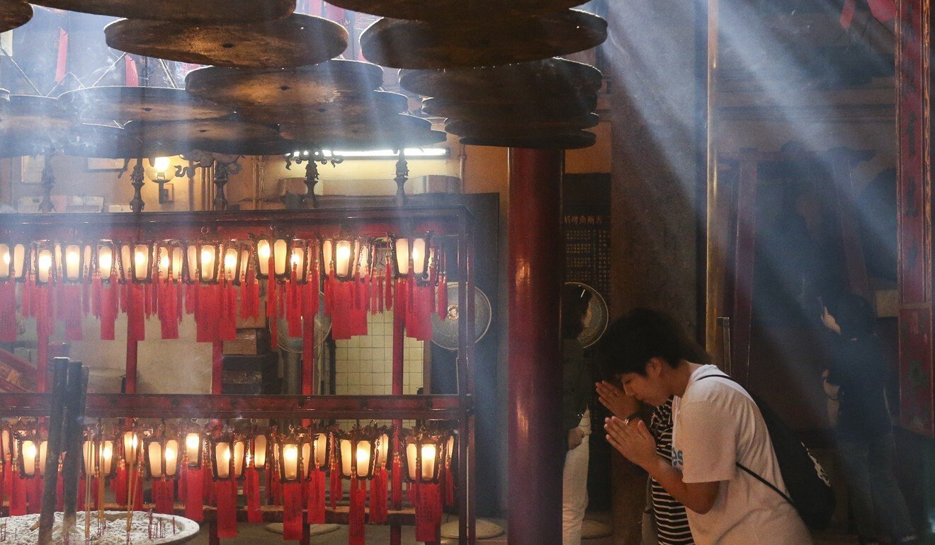 A tourist at Man Mo Temple in Sheung Wan. Photo: K.Y. Cheng