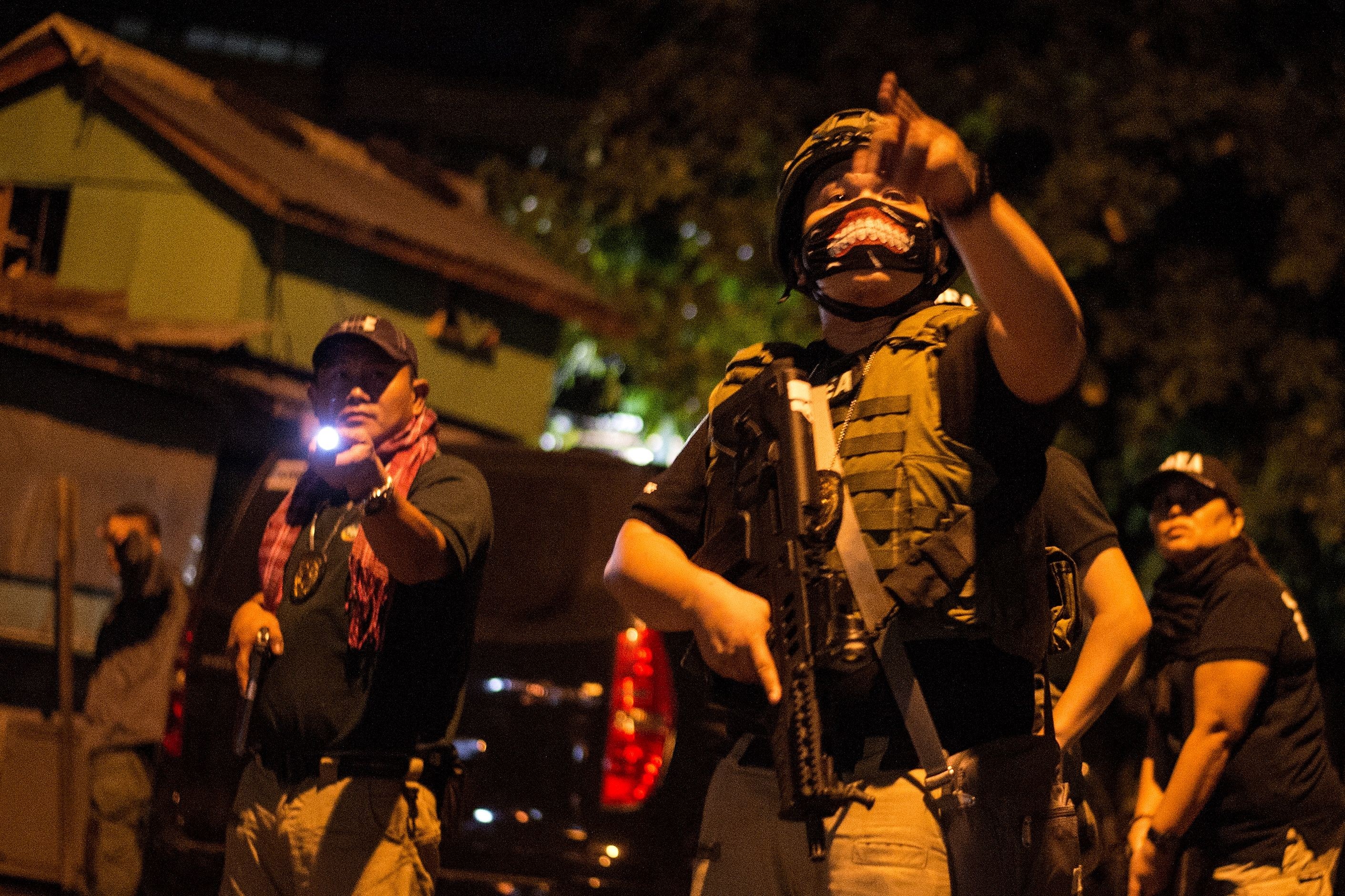 Philippine Drug Enforcement Agency agents and police carry out a raid last February. Photo: AFP