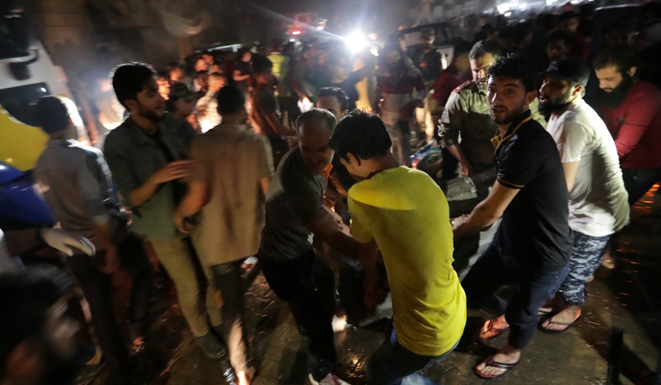 People carry a casualty away from site of a car bomb blast in Azaz. Photo: Reuters