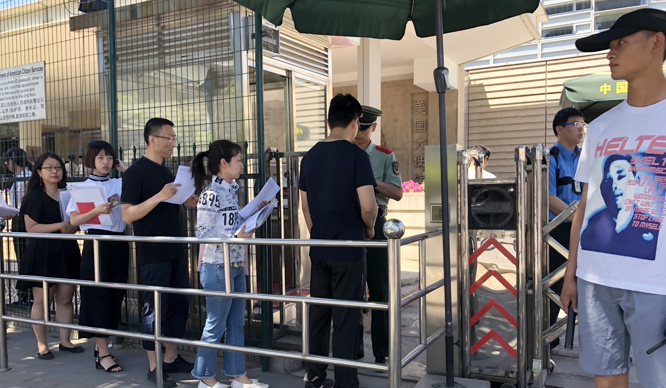 Chinese citizens lining up for visa interviews outside the American Embassy in Beijing. Photo: Simon Song