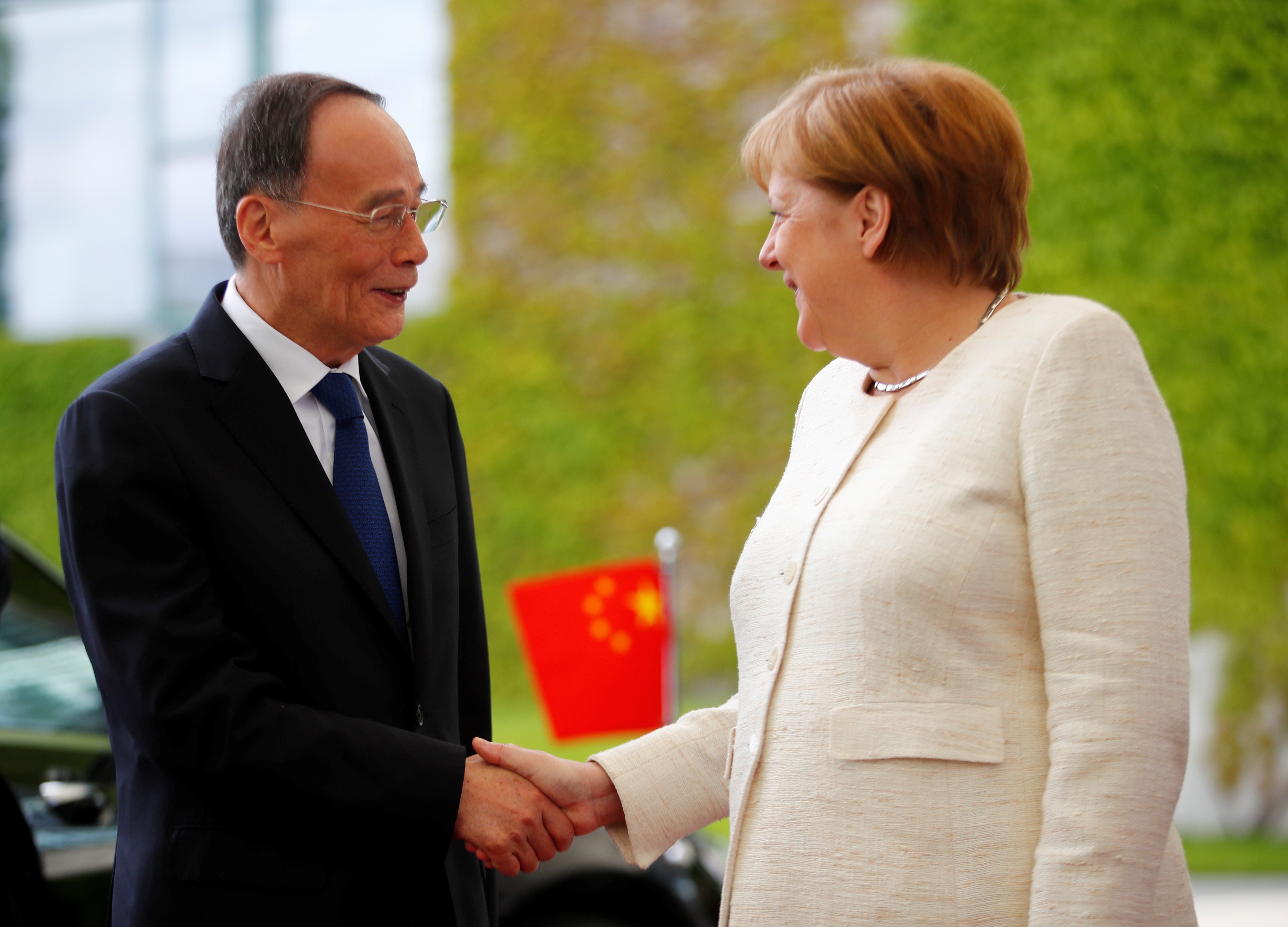 German Chancellor Angela Merkel welcomes Chinese Vice-President Wang Qishan in Berlin on Friday. Photo: Reuters