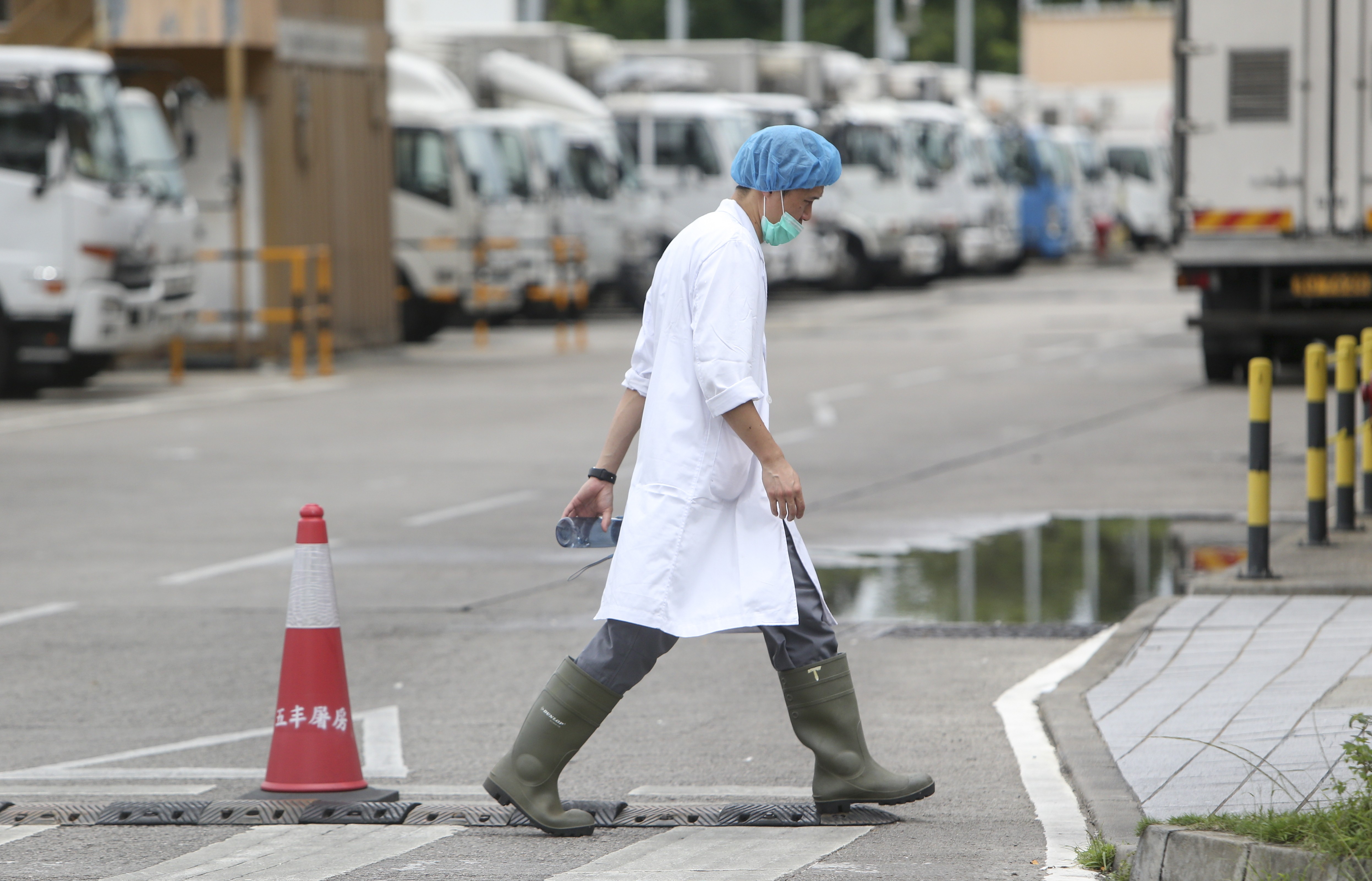 An employee dressed in protective clothing walks through the Sheung Shui facility. Photo: Winson Wong