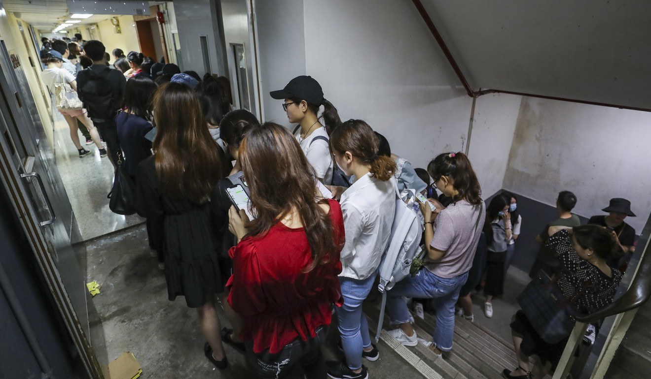 People queuing outside the AMH Medical Diagnostic Group's clinic in Jordan earlier this month after allegations surfaced over how the facility had got hold of the medical products. Photo: Winson Wong