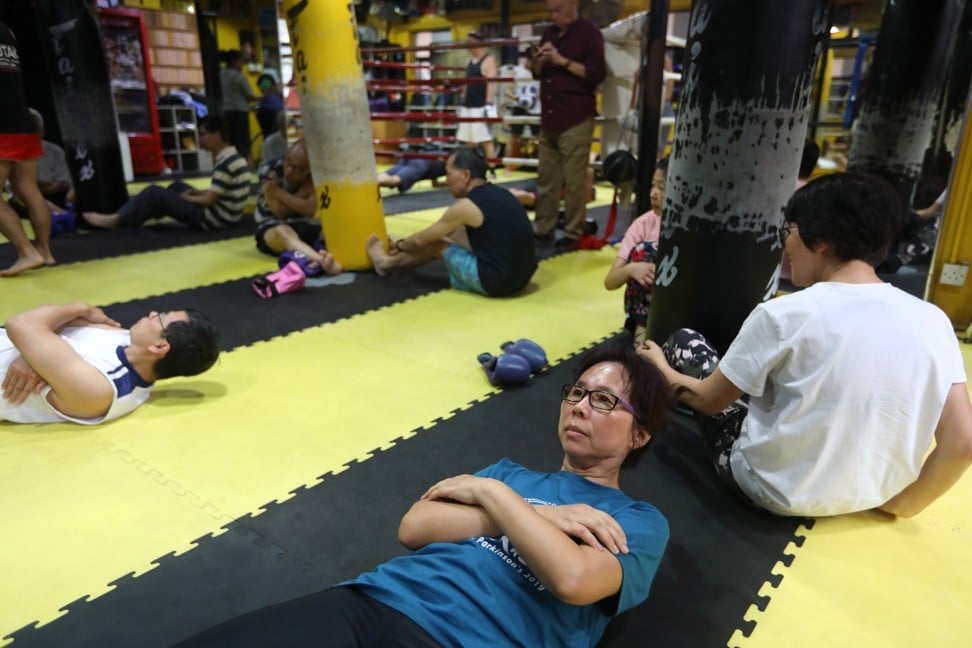 Parkinson’s patient Winnie Chan Yin (front in blue), of the Hong Kong Parkinson’s Patients Support Group, learning Muay Thai. Photo: Xiaomei Chen