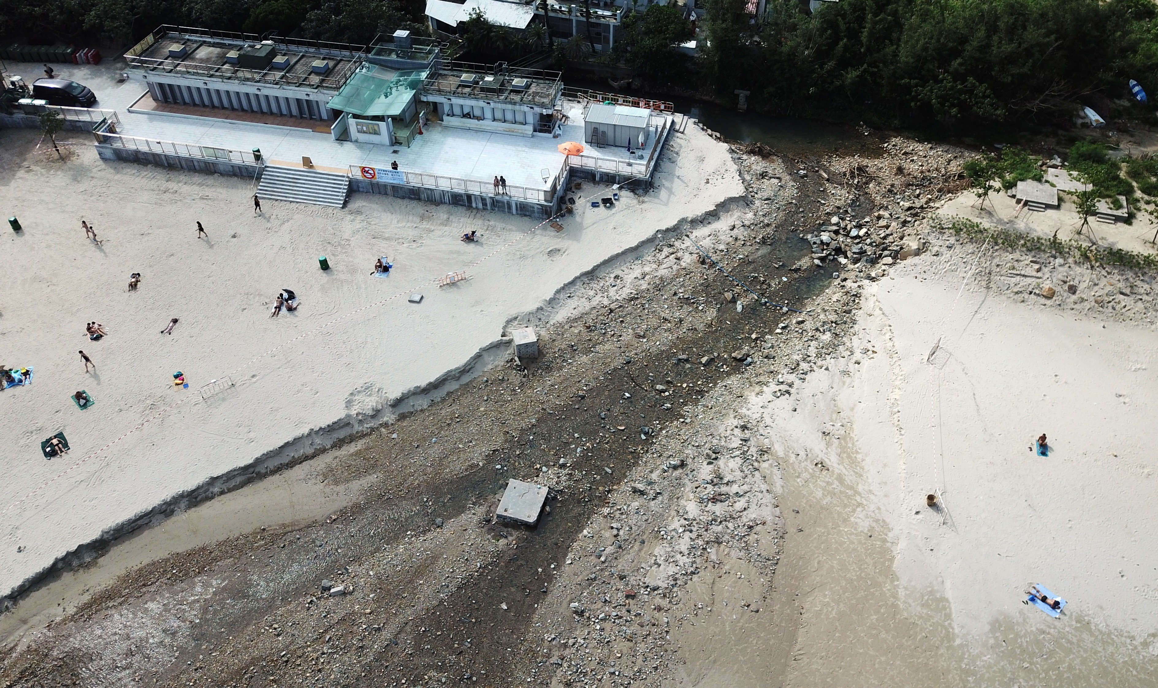 Big Wave Bay beach in Shek O on Thursday. The river broke its banks during heavy rain on Tuesday and drove a stream of rocks and debris to the sea. Photo: Antony Dickson