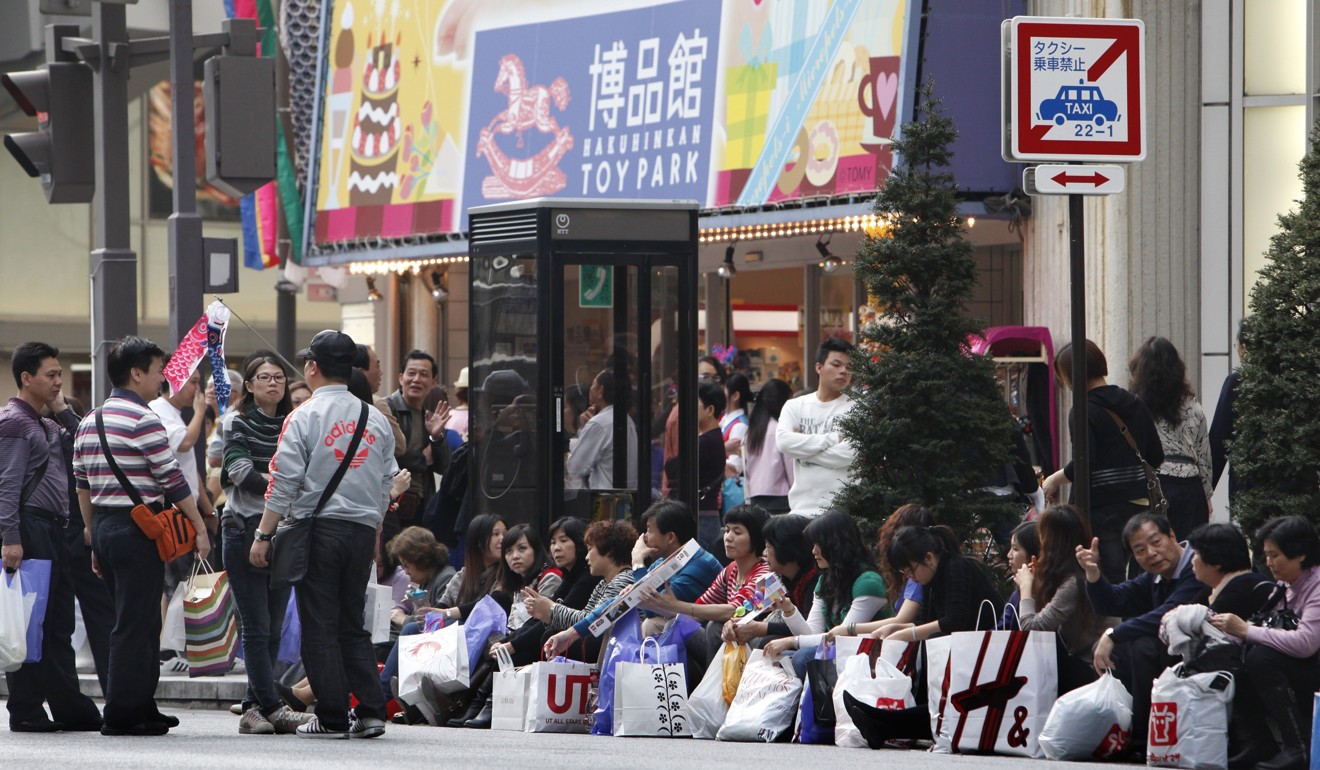 Chinese tourists take a break after shopping in Tokyo's posh Ginza district on April 22, 2010. Photo: AP