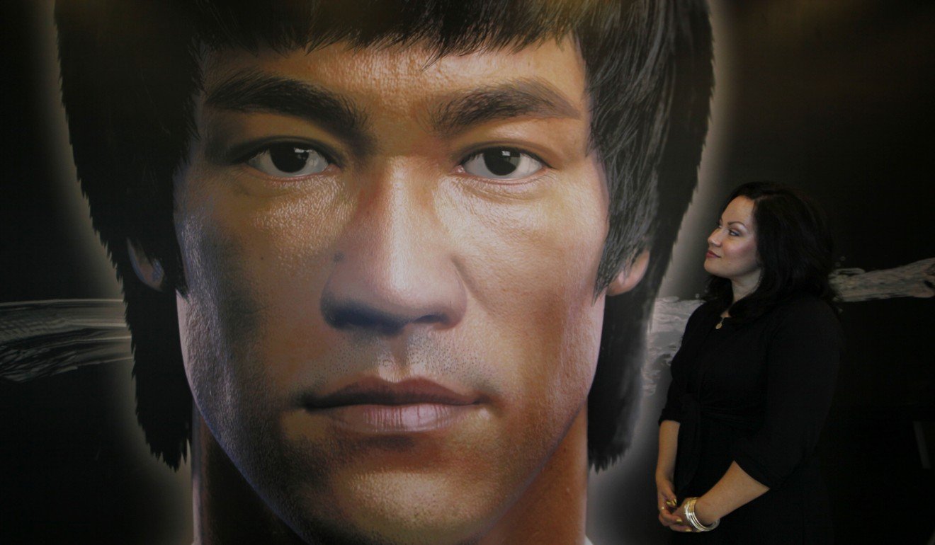 Shannon Lee, daughter of the late Kung Fu star Bruce Lee, poses in front of a promotional poster for Lee's memorial exhibition at the Hong Kong Heritage Museum Thursday, July 18, 2013 to mark the 40th anniversary of the death of Lee. Lee died on July 20, 1973. (AP Photo/Kin Cheung)