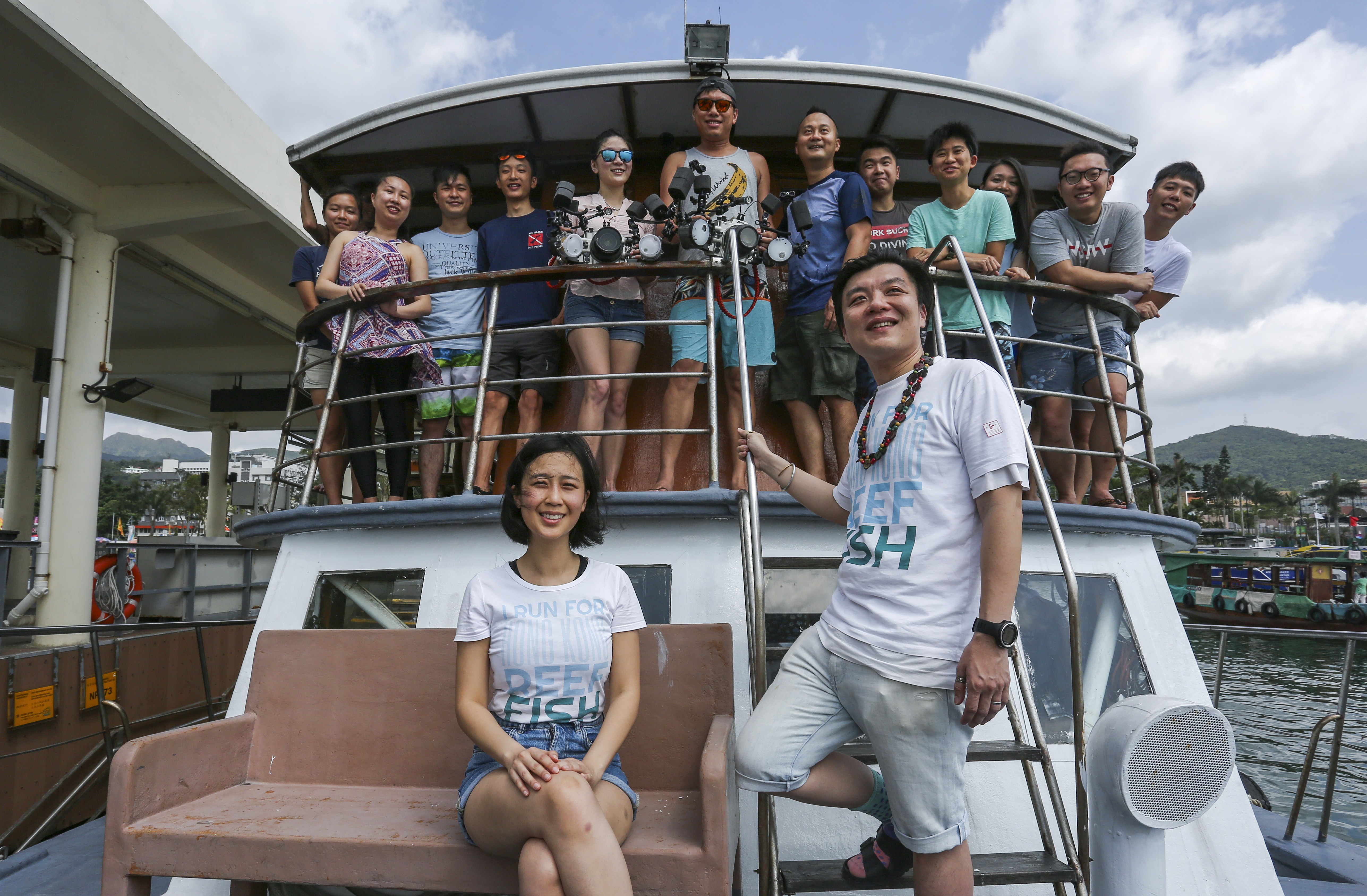 Kathleen Ho and Stan Shea, from the Bloom Association, pictured with volunteers pose for a photograph on a junk boat at Sai Kung Pier, want to see a wider appreciation of fish in Hong Kong. Photo: Jonathan Wong