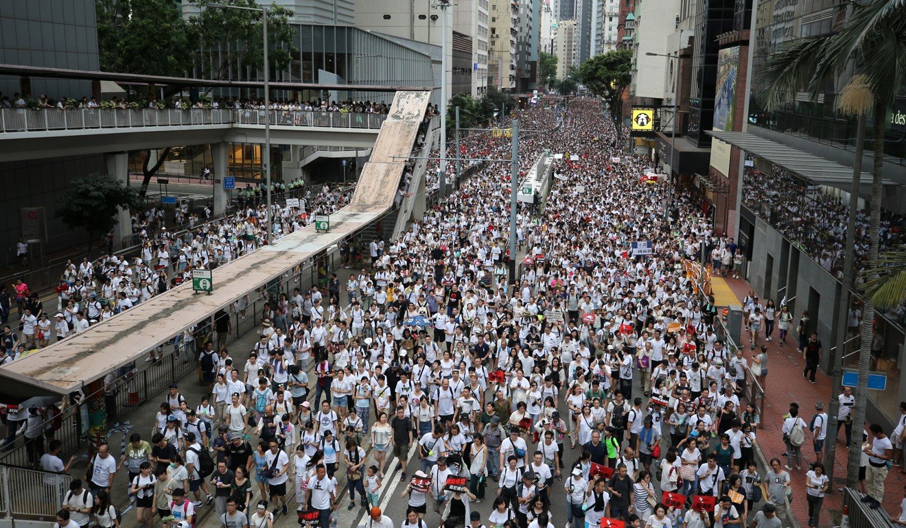 The streets are awash with white, the colour organisers asked protesters to wear. Photo: Winson Wong