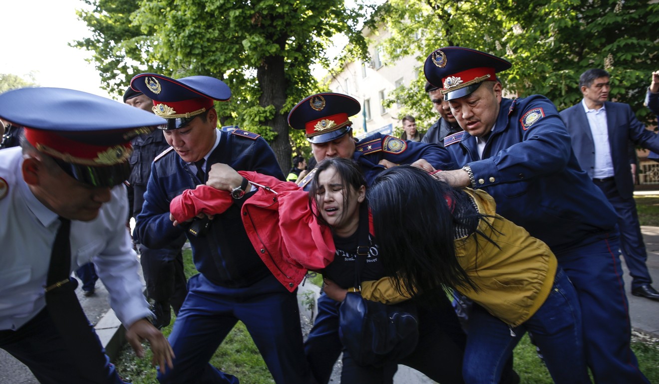 Police detain demonstrators during an anti-government protest in Almaty in May. Photo: AP