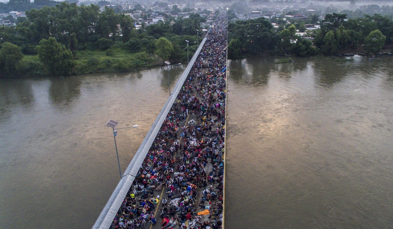 A Honduran migrant caravan heading to the US on a bridge in Mexico. Photo: AFP