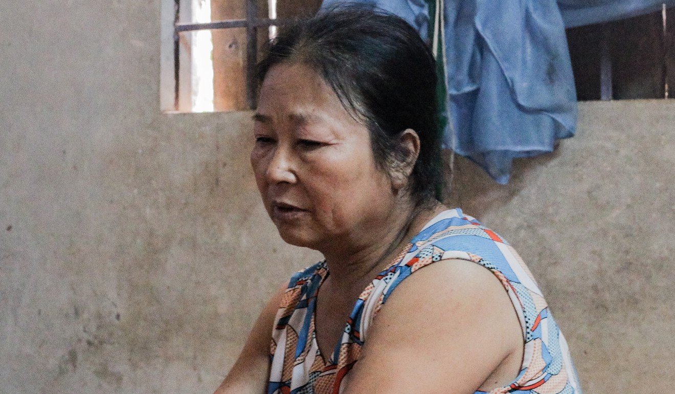 Nguyen Thi Thuy, 58, has cared for her severely disabled son since the day he was born paralysed 26 years ago. Photo: Khairul Anwar