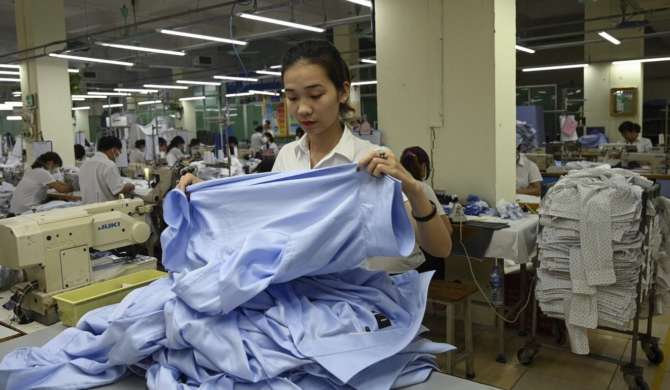 A garment factory worker preparing to stitch shirts in a factory in Hanoi. Photo: AFP