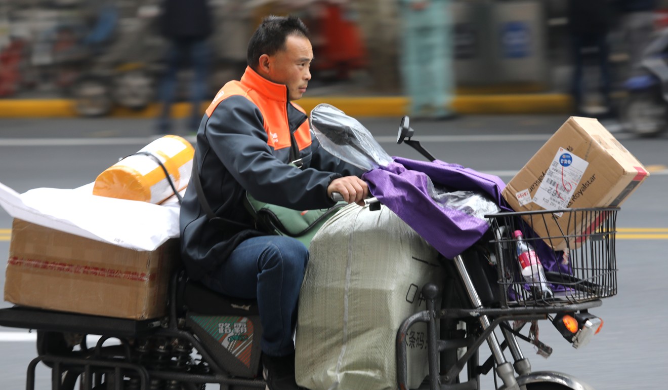 A delivery worker transports goods to online shoppers in Shanghai in November 2018. Photo: Simon Song