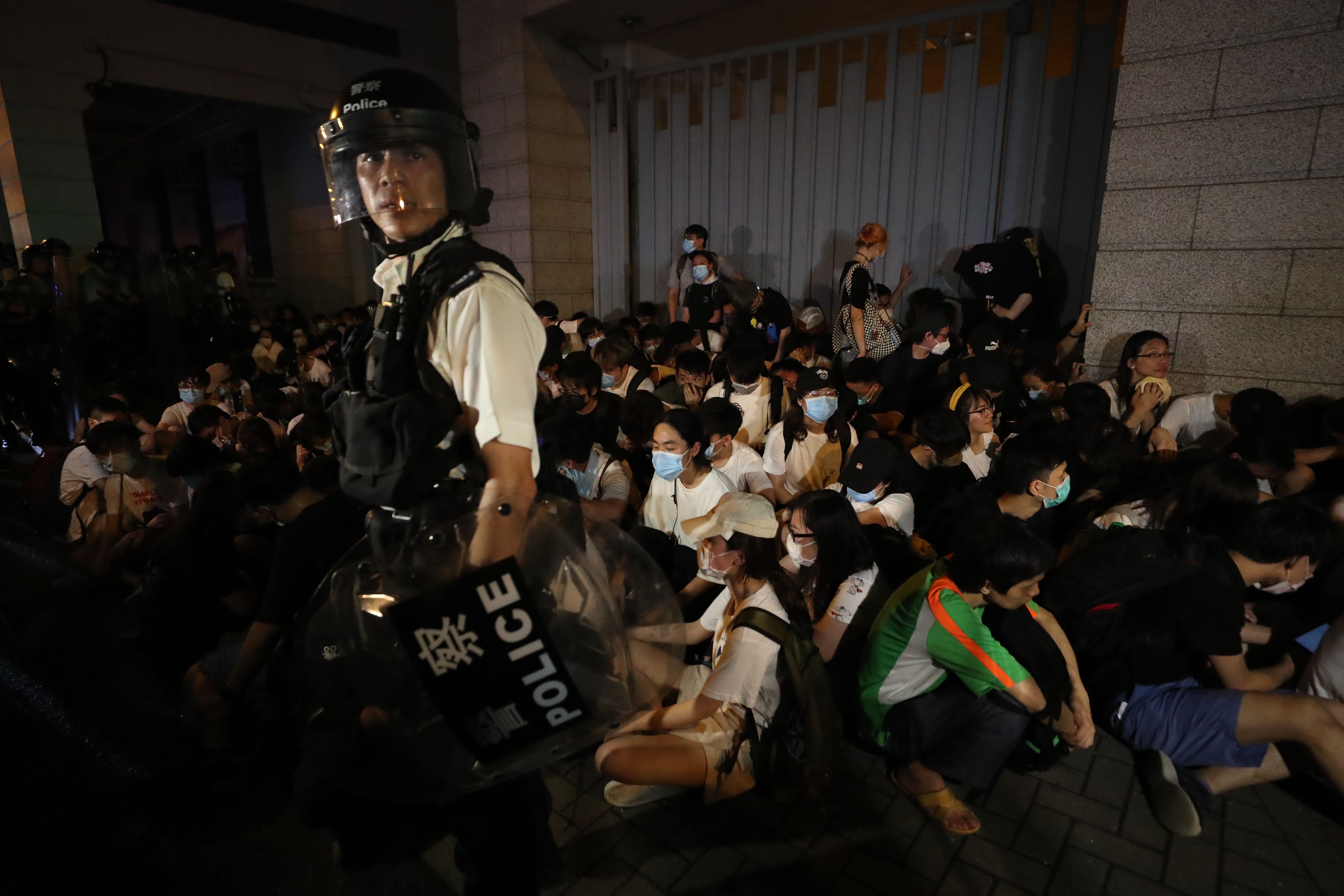 Officers have protesters corralled outside the old Wan Chai police station on Gloucester Road. Photo: Sam Tsang