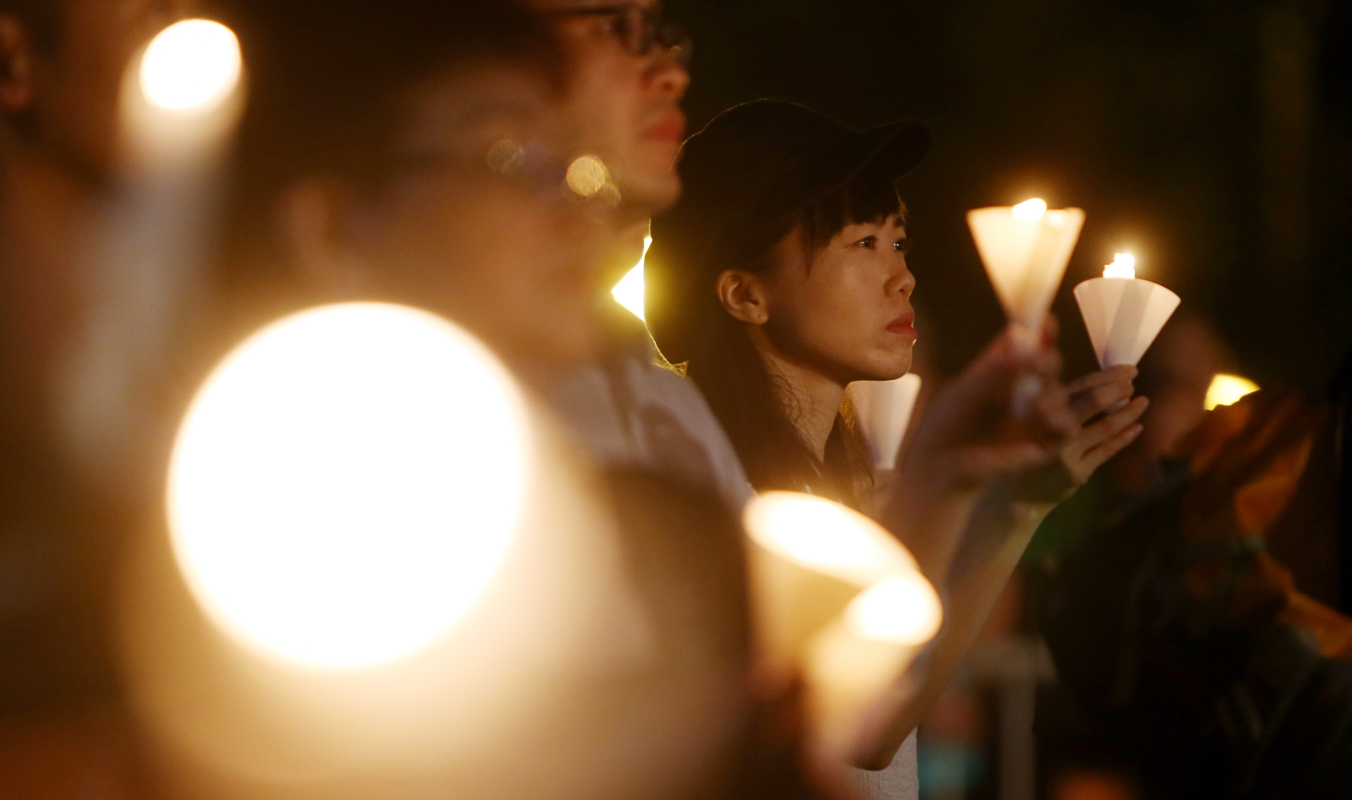 Those gathered hold up their candles in memory of the victims of the Tiananmen Square crackdown, on the 30th anniversary of the June 4 vigil in Victoria Park, Causeway Bay. Photo: Winson Wong