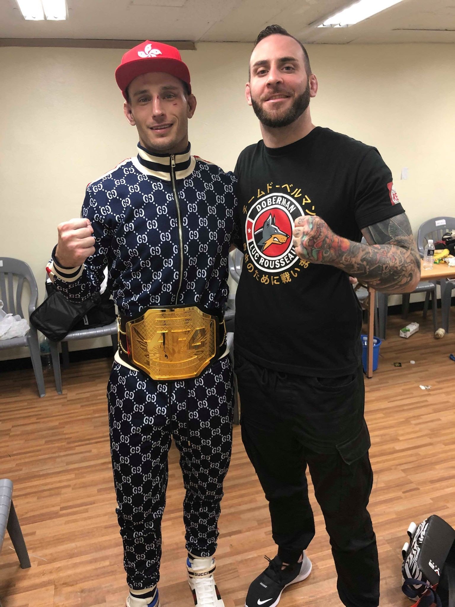Sasha Palatnikov poses with his coach after winning the AFC middleweight title. Photos: Handout