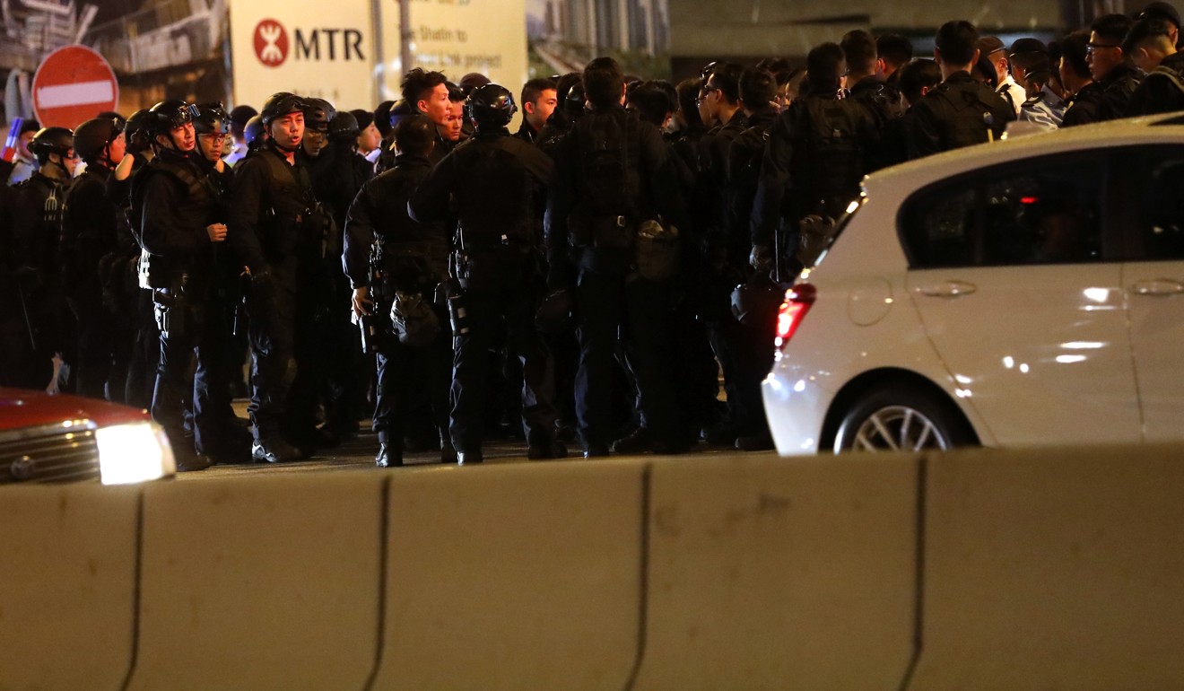 Armed officers brace for clashes after the protest march. Photo: Sam Tsang