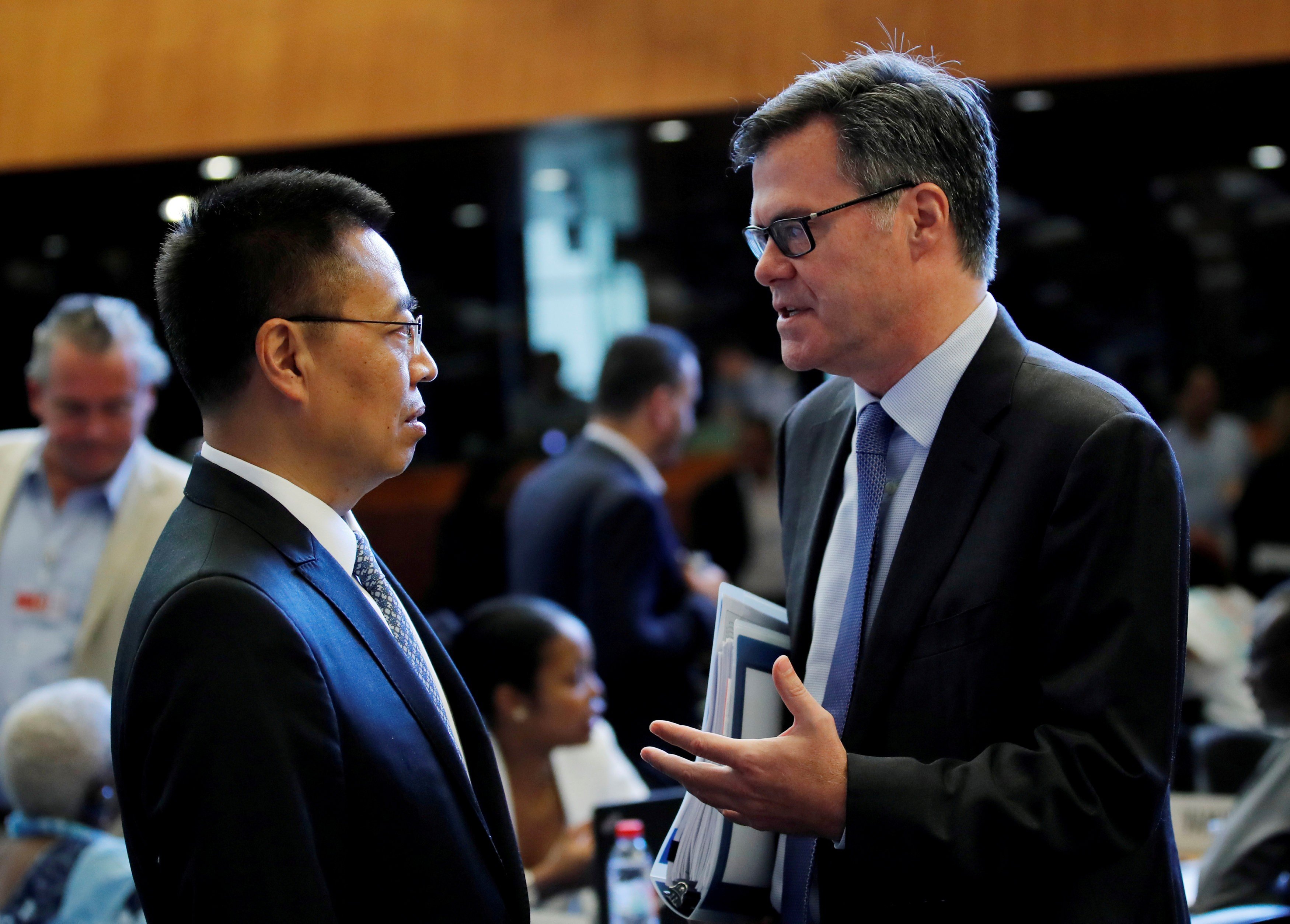 US ambassador to the WTO Dennis Shea (right) talks with his Chinese counterpart Zhang Xiangchen before the general council meeting at the World Trade Organisation in Geneva, Switzerland, on July 26, 2018. Photo: Reuters