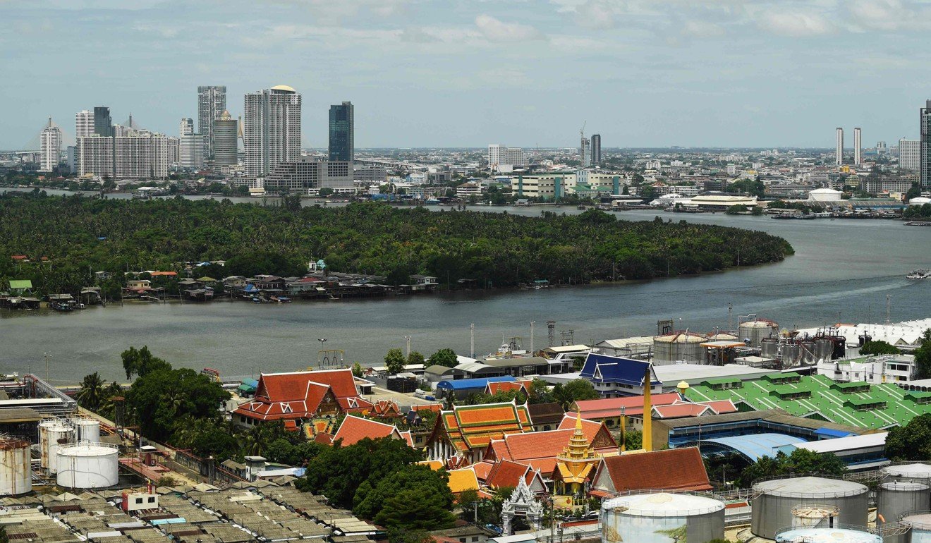 Bangkok’s main port in the foreground, and Bang Krachao or Bangkok’s “green lung”. Photo: AFP
