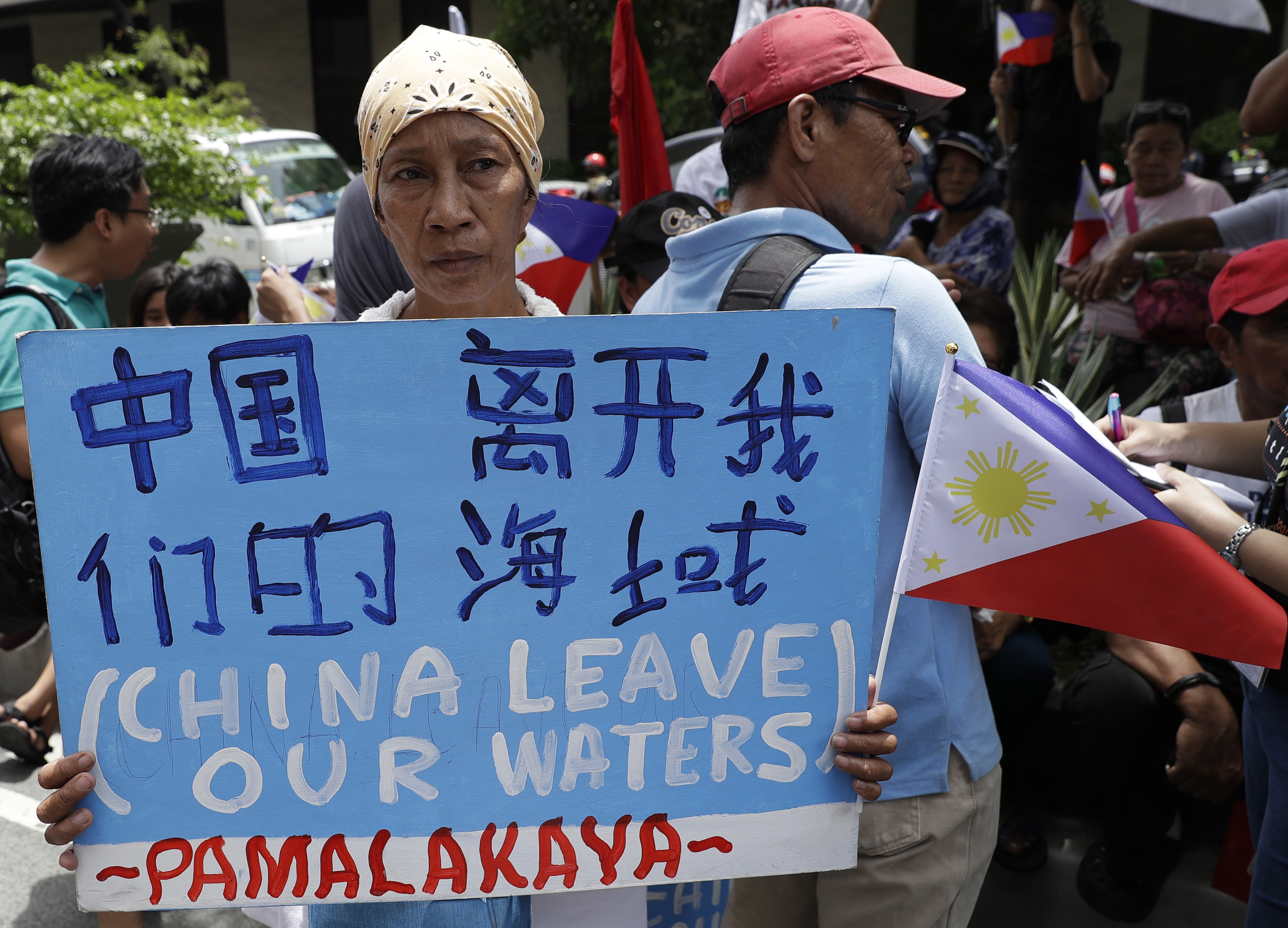 A protester outside the Chinese consulate in Manila calls for China to leave Philippine waters. Photo: AP