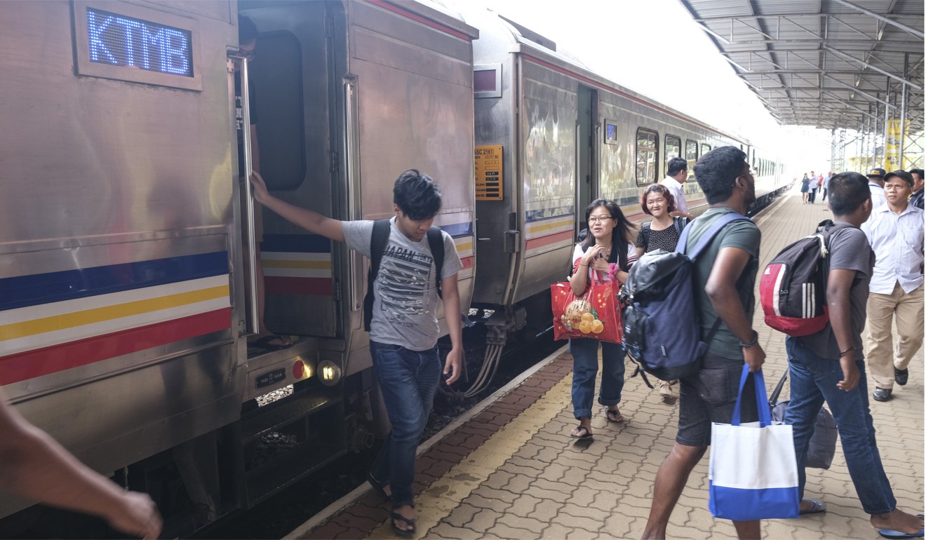 A passenger leaves the train at Gemas station. Photo: Peter Ford