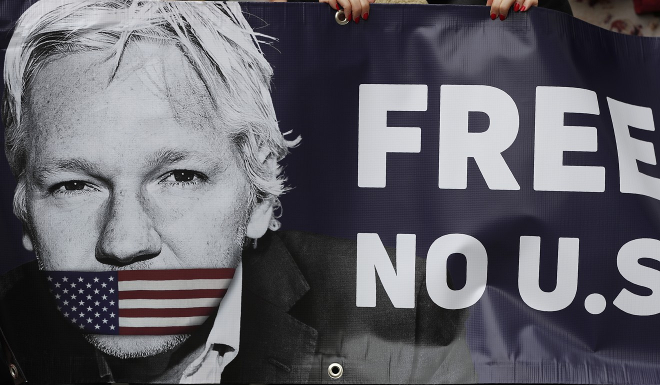 Julian Assange supporters hold a banner to protest outside a London court. Photo: AP