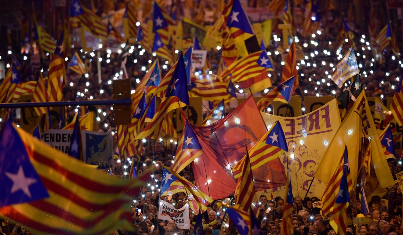 Demonstrators hold portraits of Catalan separatist Oriol Junqueras during a protest in Barcelona. Photo: AFP