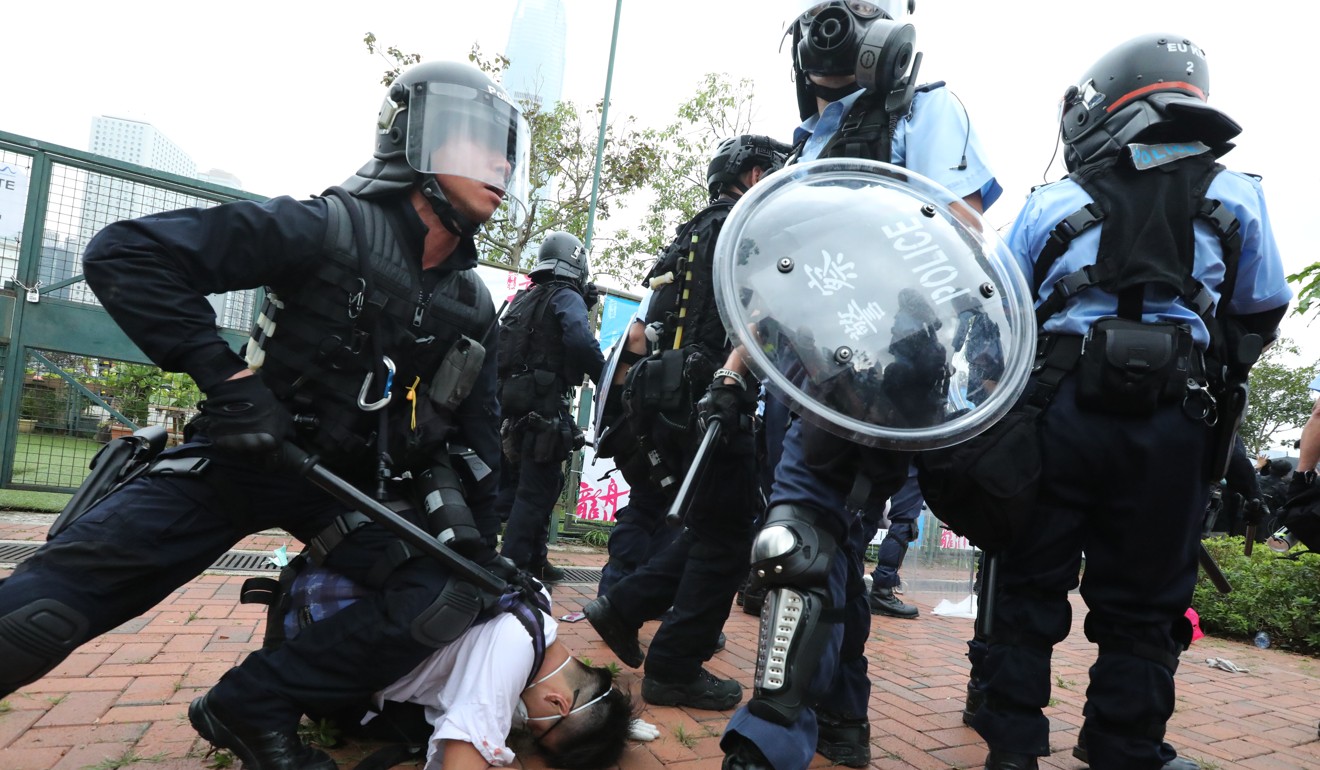 Police in anti-riot gear restrain a protester in scenes many Hongkongers have found distressing. Photo: Felix Wong