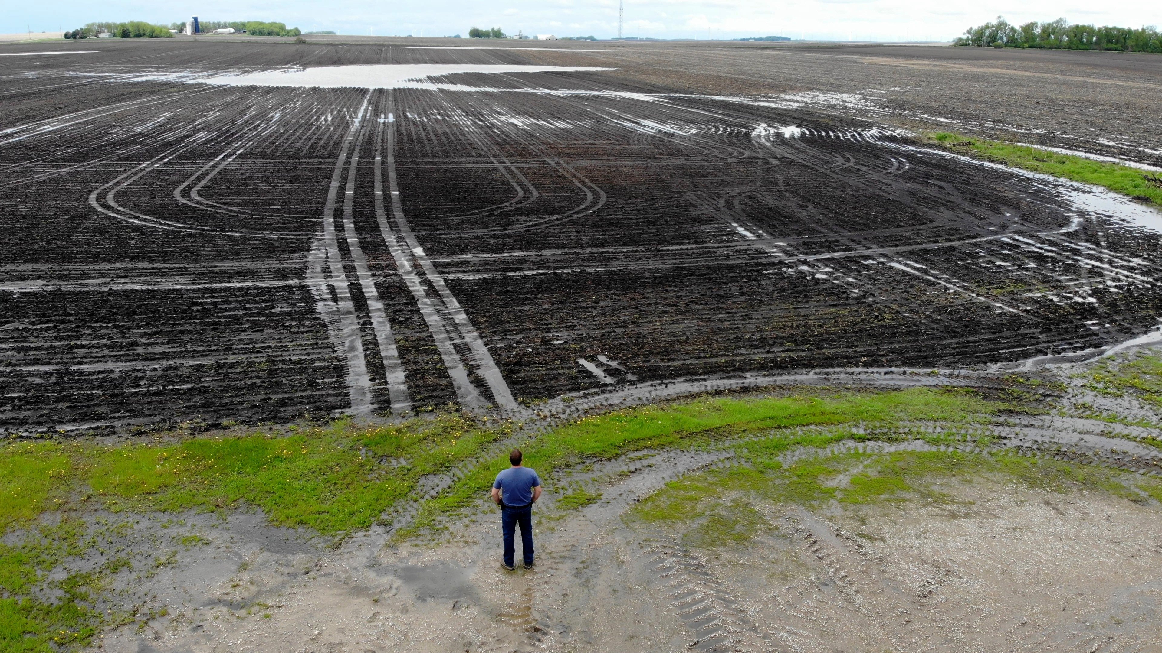 Bill Gordon, of Worthington, Minnesota, views his washed-out farmland. Photo: Xinyan Yu