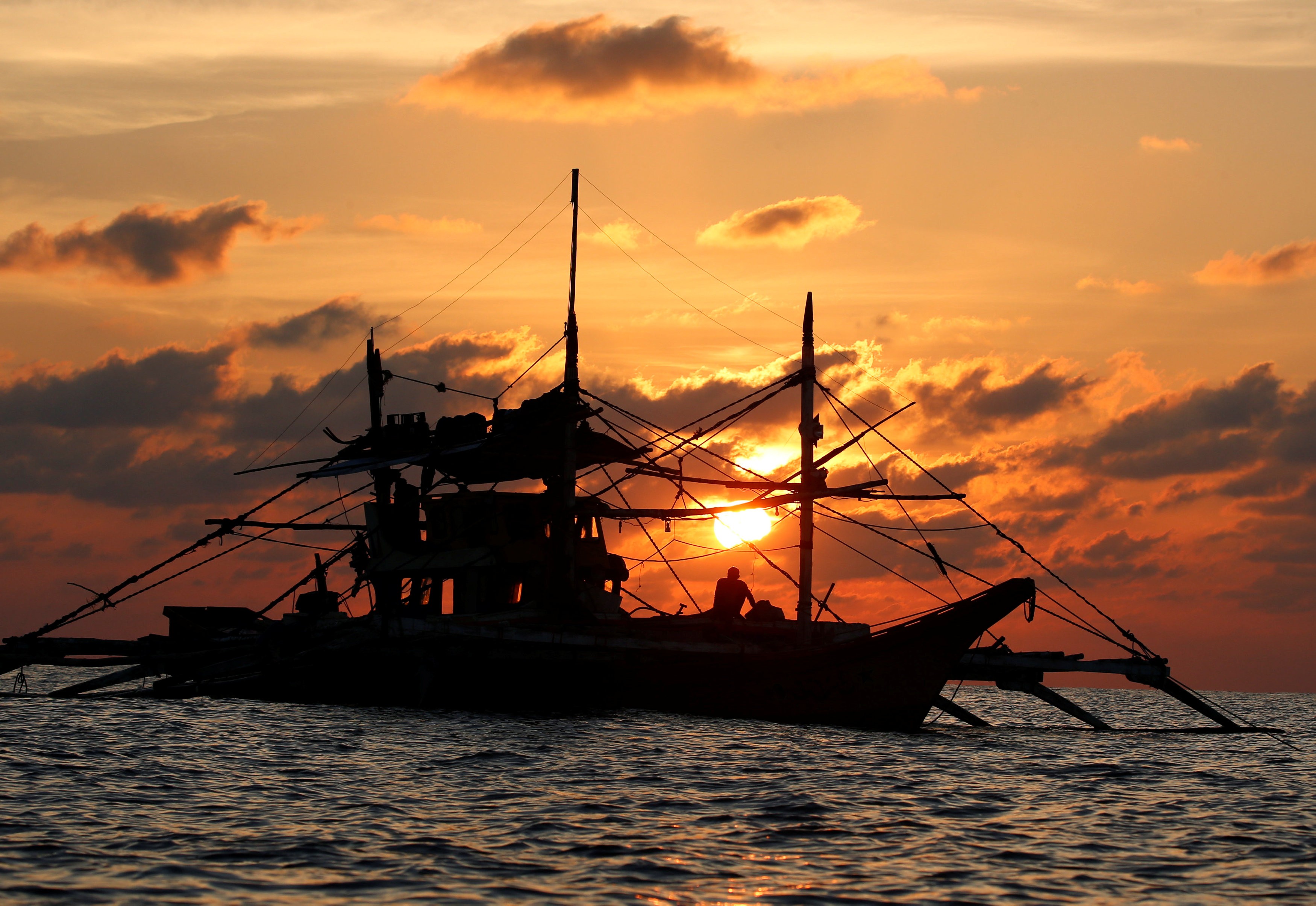 A Philippine boat fishes during sunset at the disputed Scarborough Shoal in April 2017. Photo: Reuters